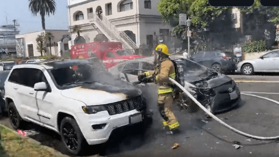 Firefighters extinguished two burning vehicles that were set ablaze by a woman in the Hollywood Hills on July 13, 2024. (Citizen)