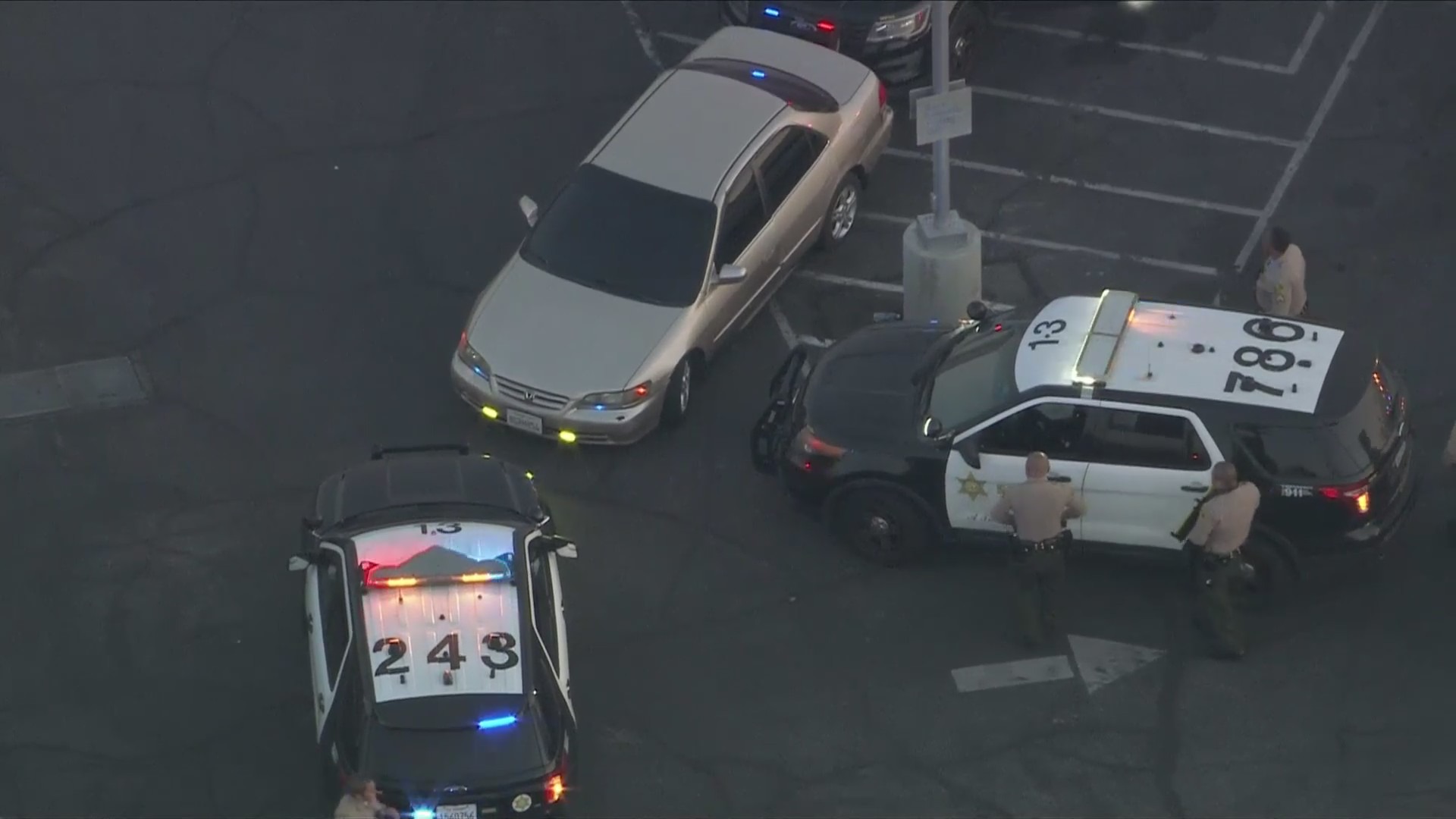 Patrol cars surround the suspect's vehicle in Compton following a multi-city pursuit on July 5, 2024. (KTLA)