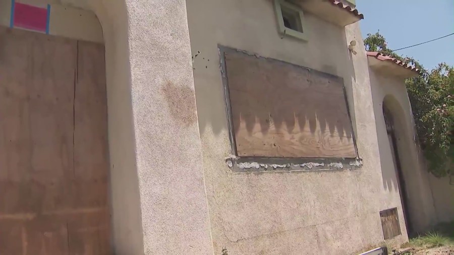 A West Hollywood home remains boarded up on July 2, 2024 after a large fire  was ignited amid complaints of squatters constantly trespassing. (KTLA)