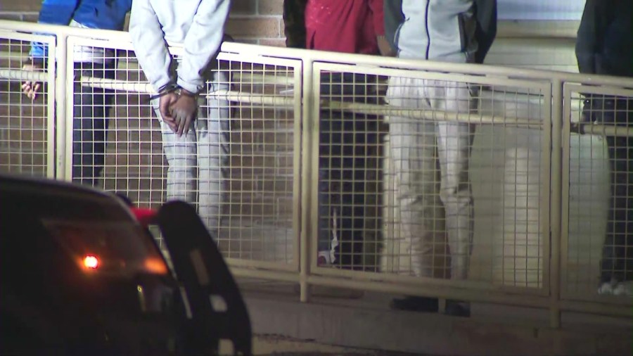 Teen suspects were seen being handcuffed and detained after a large disturbance forced a Carson shopping mall to close on July 6, 2024. (KTLA)