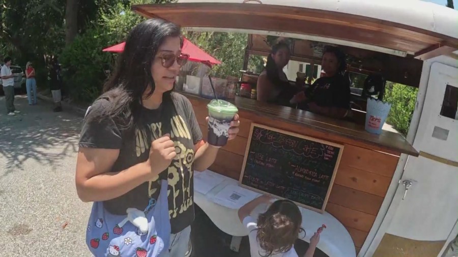 Customers enjoying drinks from the Ka-Ibigan Cafe coffee cart in Altadena on July 9, 2024. (KTLA)