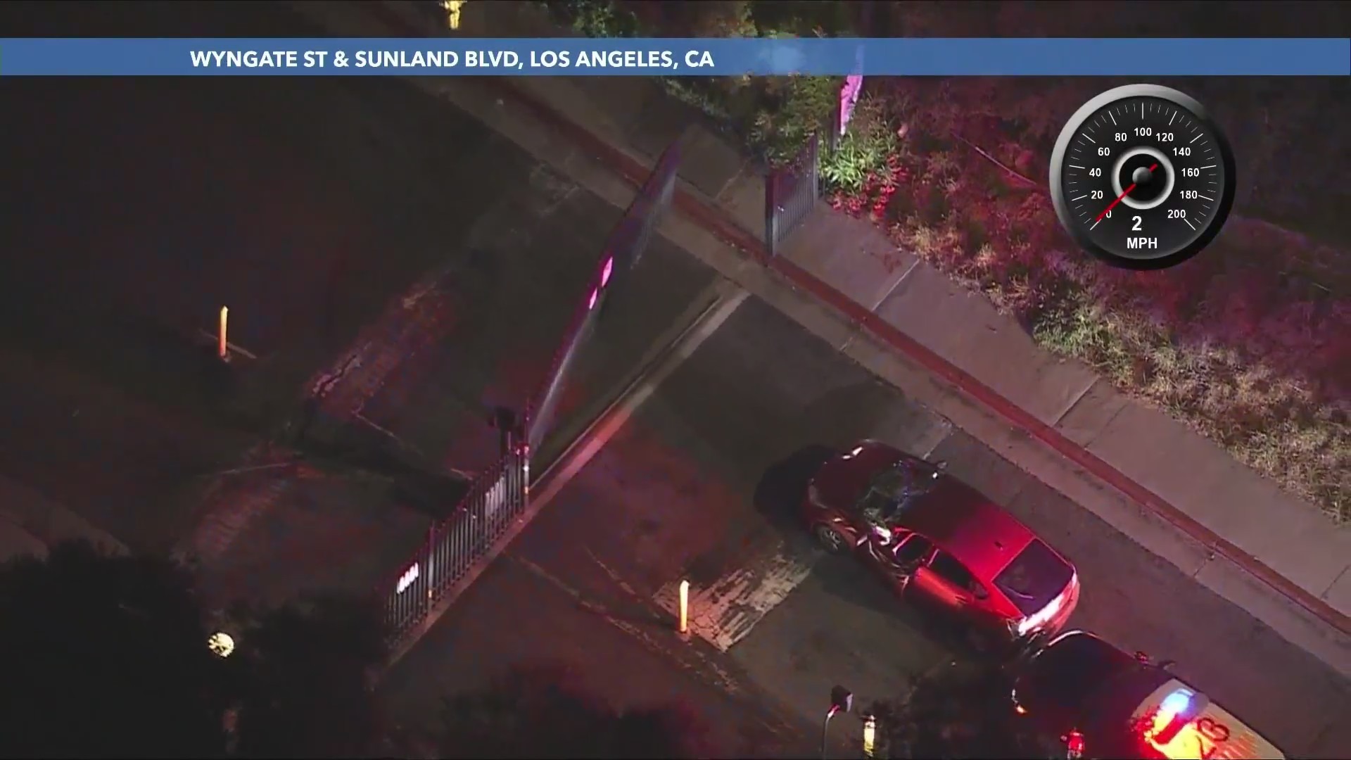 The suspect tried ramming the metal gate of an apartment complex but failed. He jumped out of the car and ran into the complex. (KTLA)