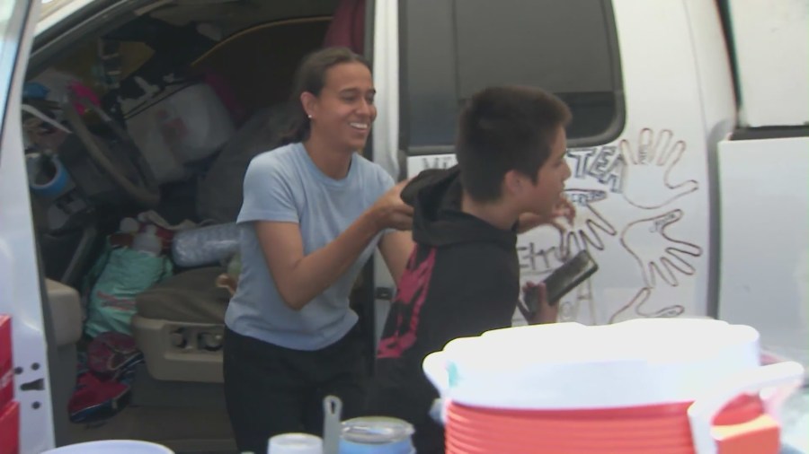 The Morales family, who are homeless, are seen spending an afternoon together outside of the truck they live in at a Pacoima park on July 4, 2024. (KTLA)