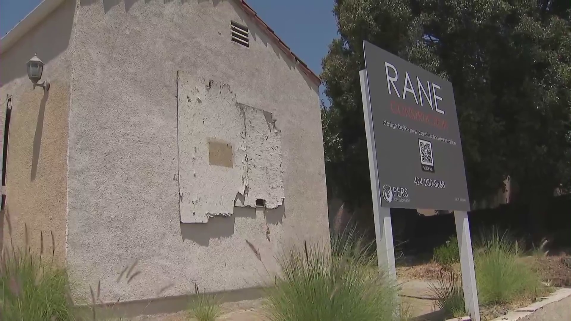 A West Hollywood home remains boarded up on July 2, 2024 after a large fire was ignited amid complaints of squatters constantly trespassing. (KTLA)