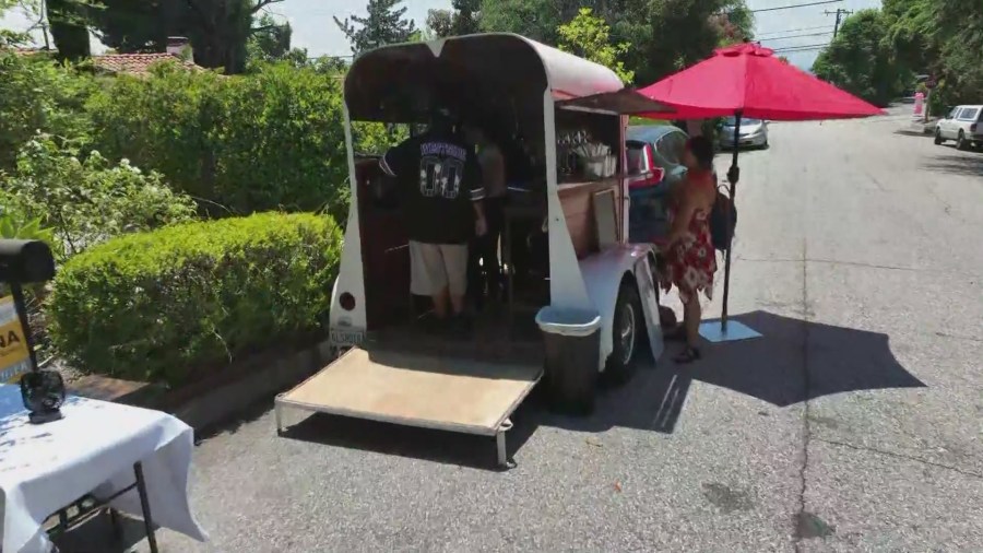 Customers enjoying drinks from the Ka-Ibigan Cafe coffee cart in Altadena on July 9, 2024. (KTLA)