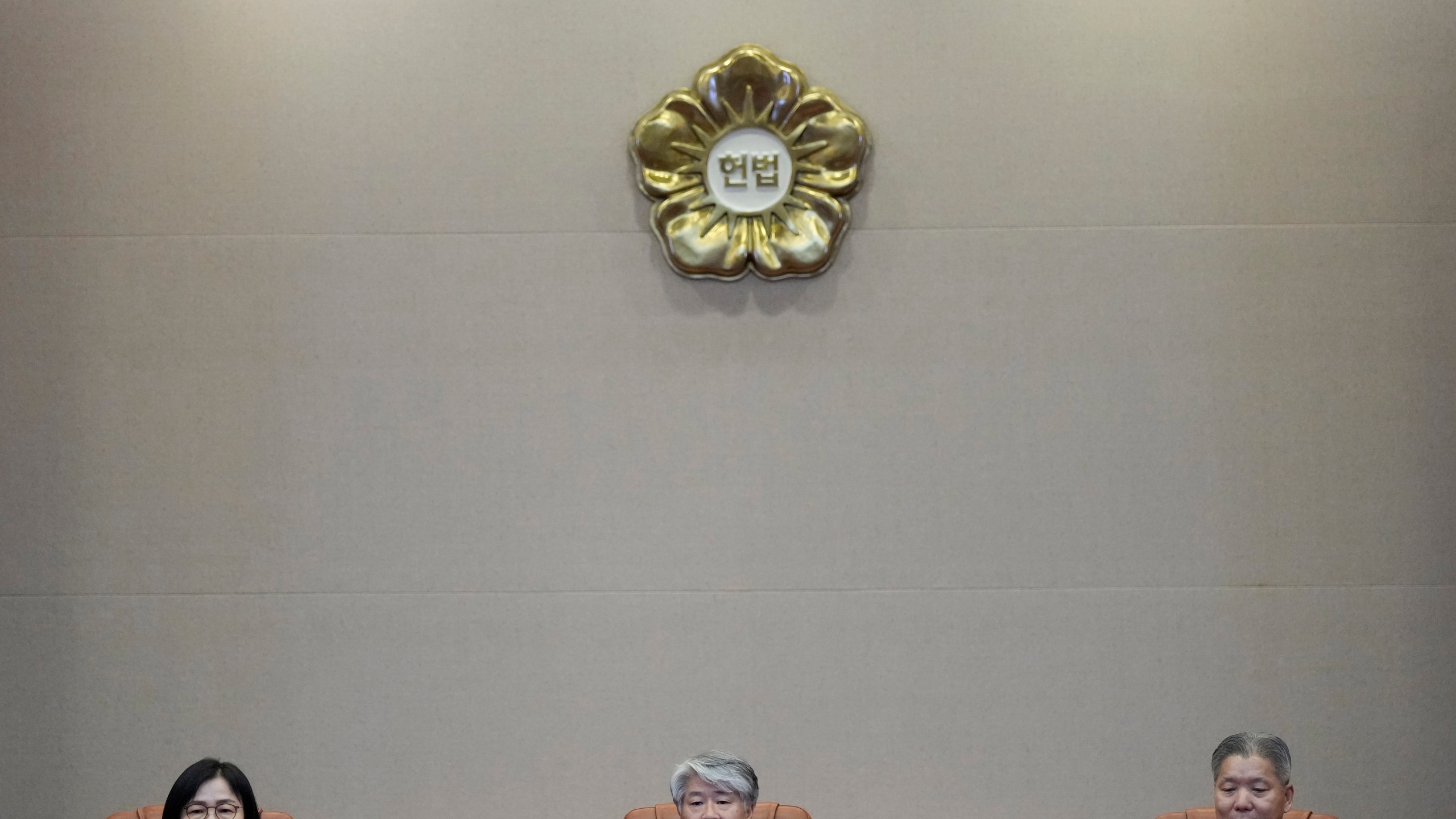 South Korea's Constitutional Court Chief Justice Lee Jong-seok, center, and other judges sit upon their arrival at the Constitutional Court in Seoul, South Korea, Thursday, Aug. 29, 2024. (AP Photo/Lee Jin-man)