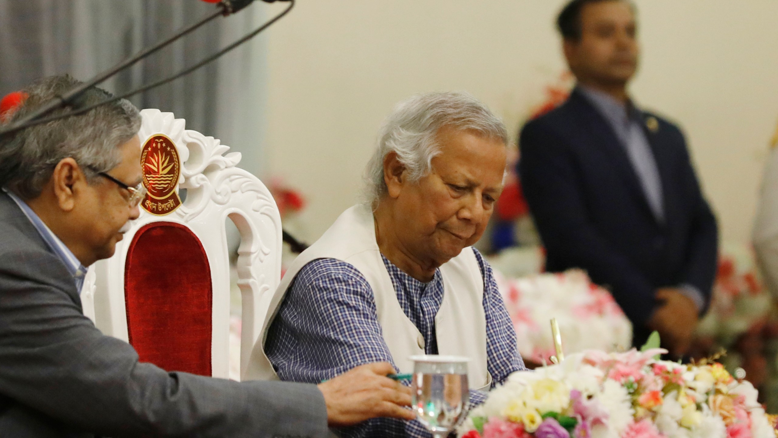 Nobel laureate Muhammad Yunus signs a document after taking the oath of office as the head of Bangladesh's interim government, in Dhaka, Bangladesh, Thursday, Aug. 8, 2024. (AP Photo/Rajib Dhar)