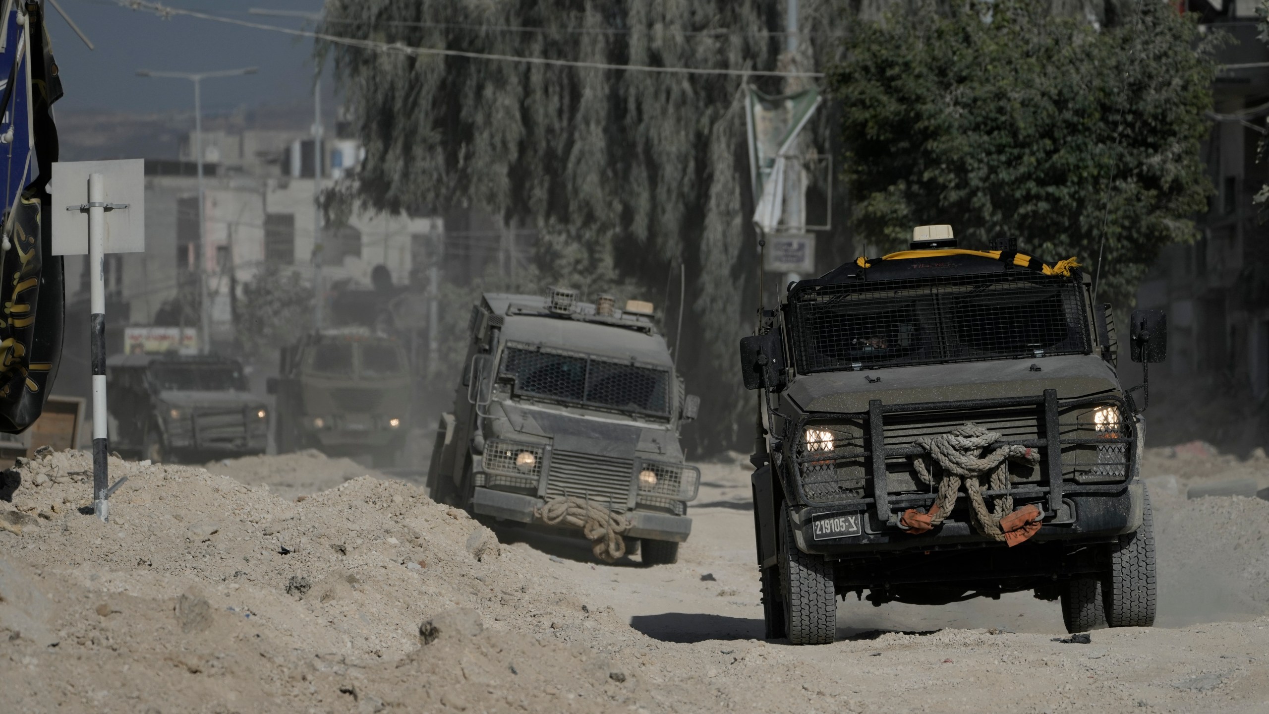 Israeli armoured vehicles move on a street during a military operation in the West Bank refugee camp of Nur Shams, Tulkarem, Thursday, Aug. 29, 2024. (AP Photo/Majdi Mohammed)