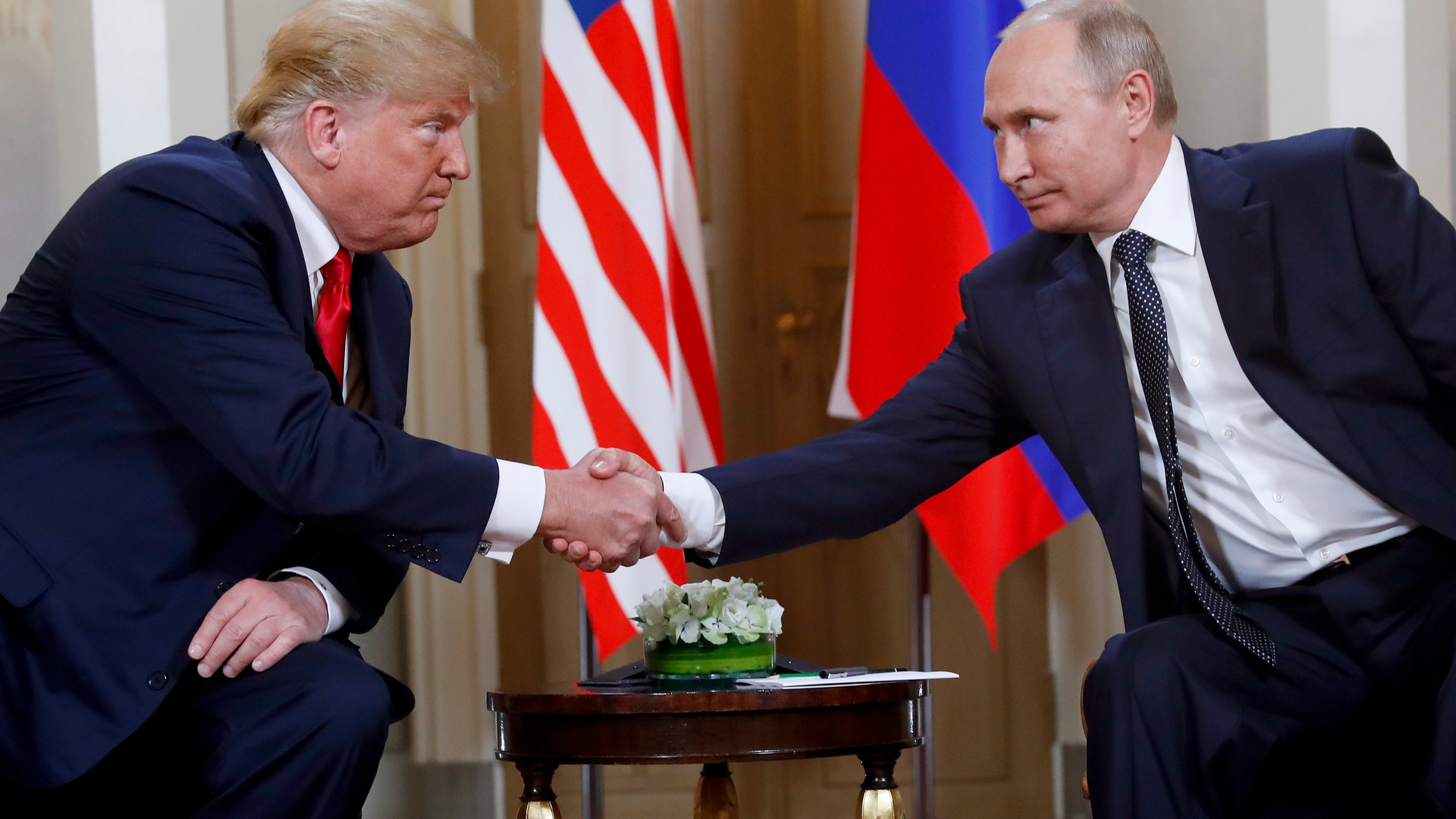 FILE - President Donald Trump, left, and Russian President Vladimir Putin shake hands at the beginning of a meeting at the Presidential Palace in Helsinki, Finland, July 16, 2018. (AP Photo/Pablo Martinez Monsivais, File)