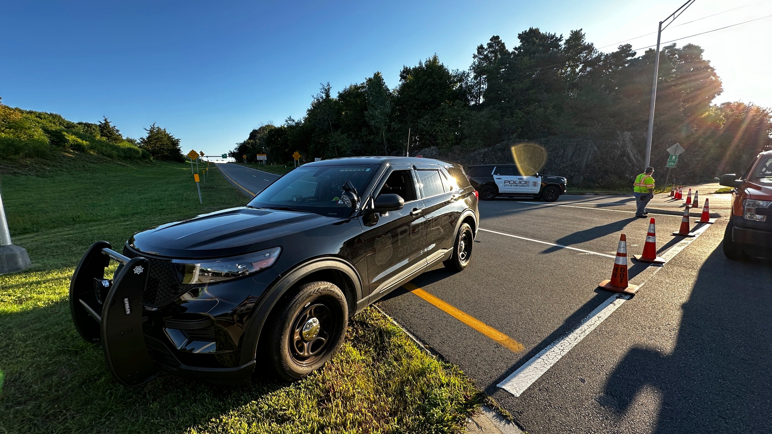 Police block a ramp to Interstate 95 and the Piscataqua River Bridge in Portsmouth, N.H. after a man connected to a homicide was fatally shot by police and an 8-year-old child was found shot to death in the man’s car on the bridge that connects New Hampshire to Maine, Thursday, Aug. 29, 2024. (AP Photo/Caleb Jones)