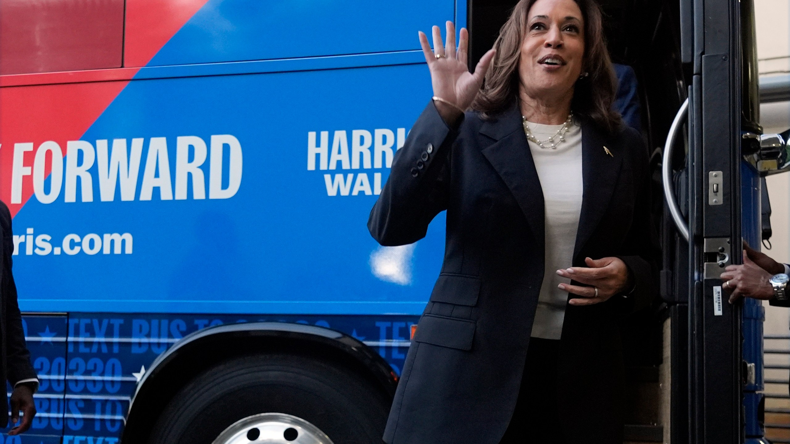 Democratic presidential nominee Vice President Kamala Harris waves as she exits her campaign bus in Savannah, Ga., Wednesday, Aug. 28, 2024. (AP Photo/Jacquelyn Martin)