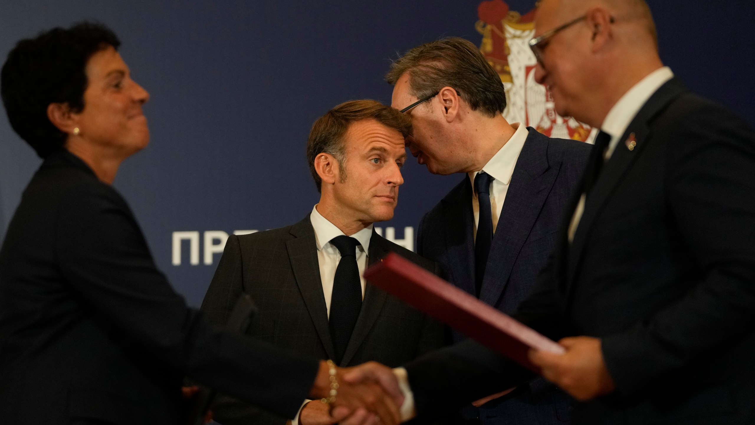 French President Emmanuel Macron, left, and Serbian President Aleksandar Vucic speak after the signing of bilateral documents in Belgrade, Serbia, Thursday, Aug. 29, 2024. French President Emmanuel Macron starts a two-day state visit to Serbia with the focus on a possible sale of 12 Rafale multi-purpose fighter jets to a country that has maintained close ties to Russia despite its aggression on Ukraine. (AP Photo/Darko Vojinovic)