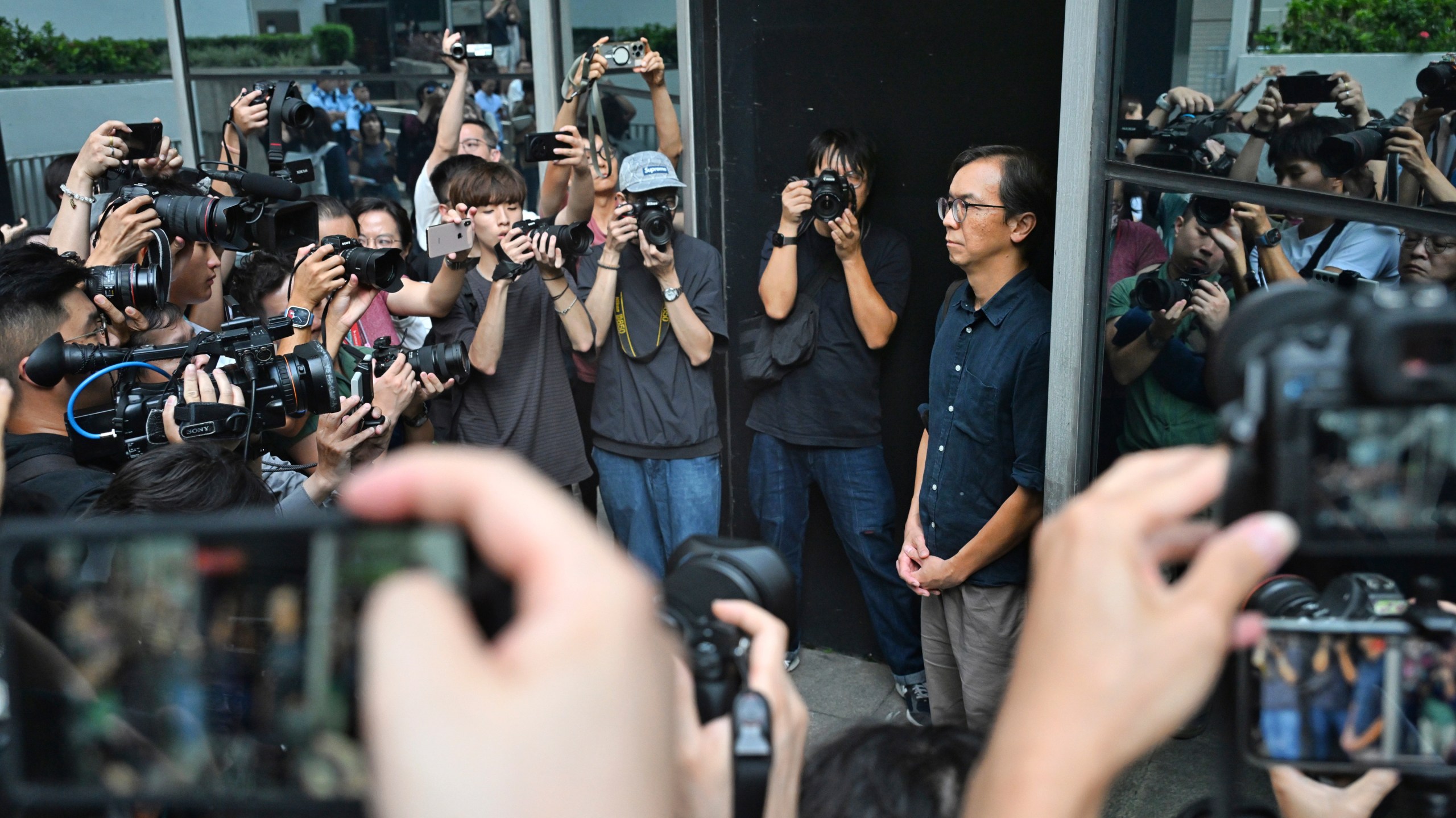 Chung Pui-kuen, the former chief editor of Hong Kong's now-shuttered outlet Stand News, walks outside on bail after he was found guilty in a landmark sedition trial under a colonial-era law, in Wanchai District Court in Hong Kong on Thursday, Aug. 29, 2024. (AP Photo/Billy H.C. Kwok)