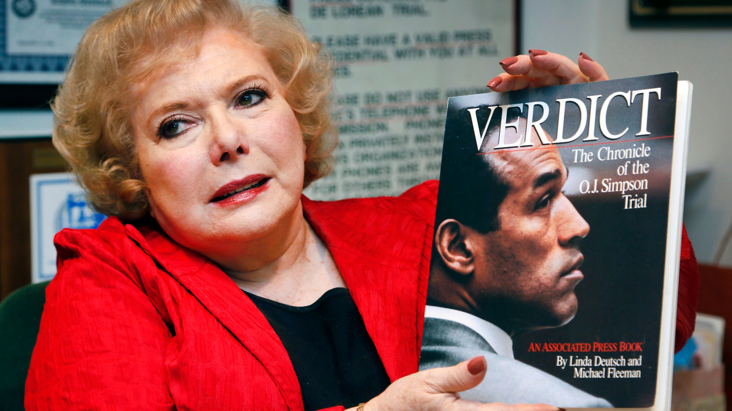 FILE - Associated Press special correspondent Linda Deutsch holds a copy of her book, "Verdict, The Chronicle of the O.J. Simpson Trial," at her home in Los Angeles, Dec. 11, 2014. (AP Photo/Nick Ut, File)