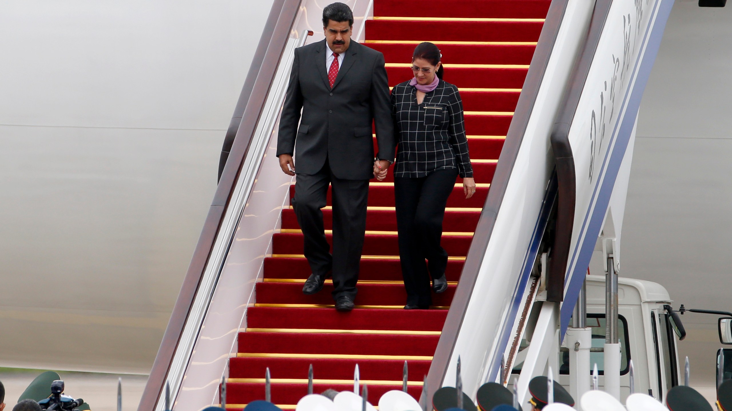 FILE - Venezuela's President Nicolas Maduro, left, and first lady Cilia Flores arrive at Beijing Capital International Airport in Beijing, China, Sept. 1, 2015. (AP Photo/Ng Han Guan, File)