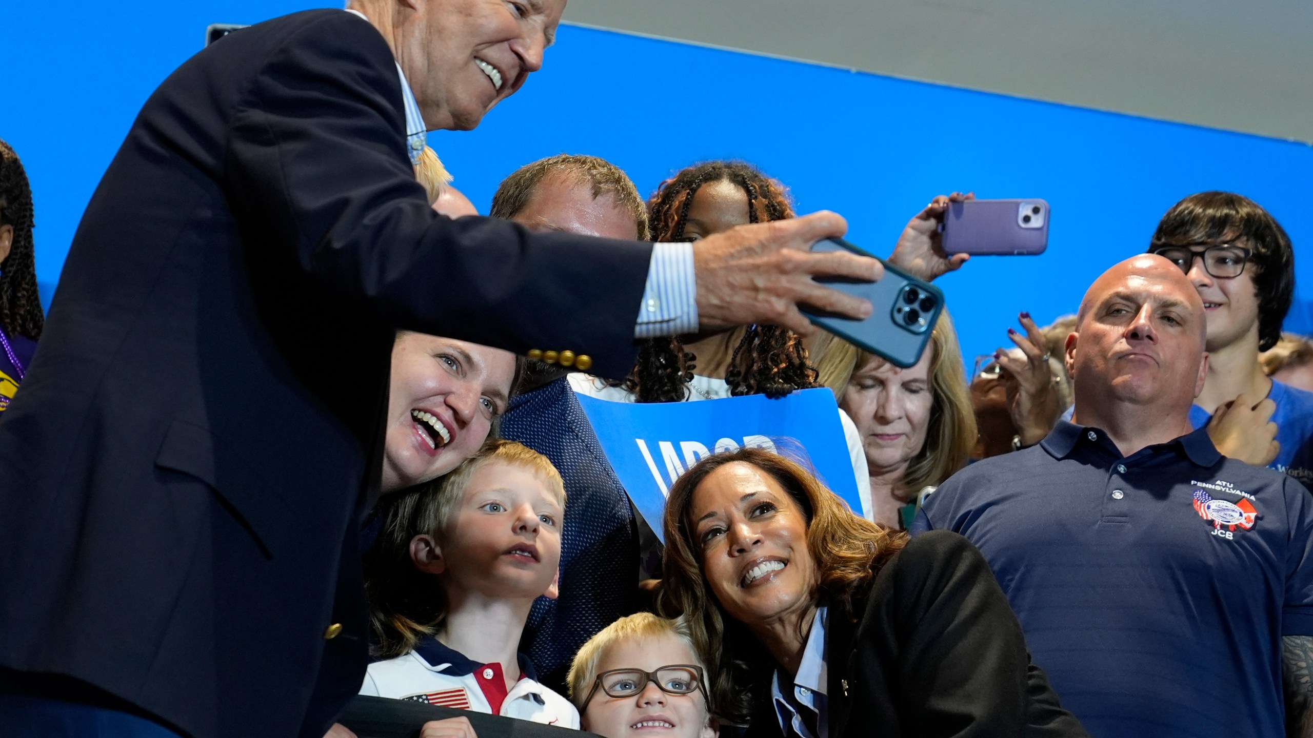 President Joe Biden take a photo as Democratic presidential nominee Vice President Kamala Harris poses as they campaign at the IBEW Local Union #5 union hall in Pittsburgh on Labor Day, Monday, Sept. 2, 2024. (AP Photo/Susan Walsh)