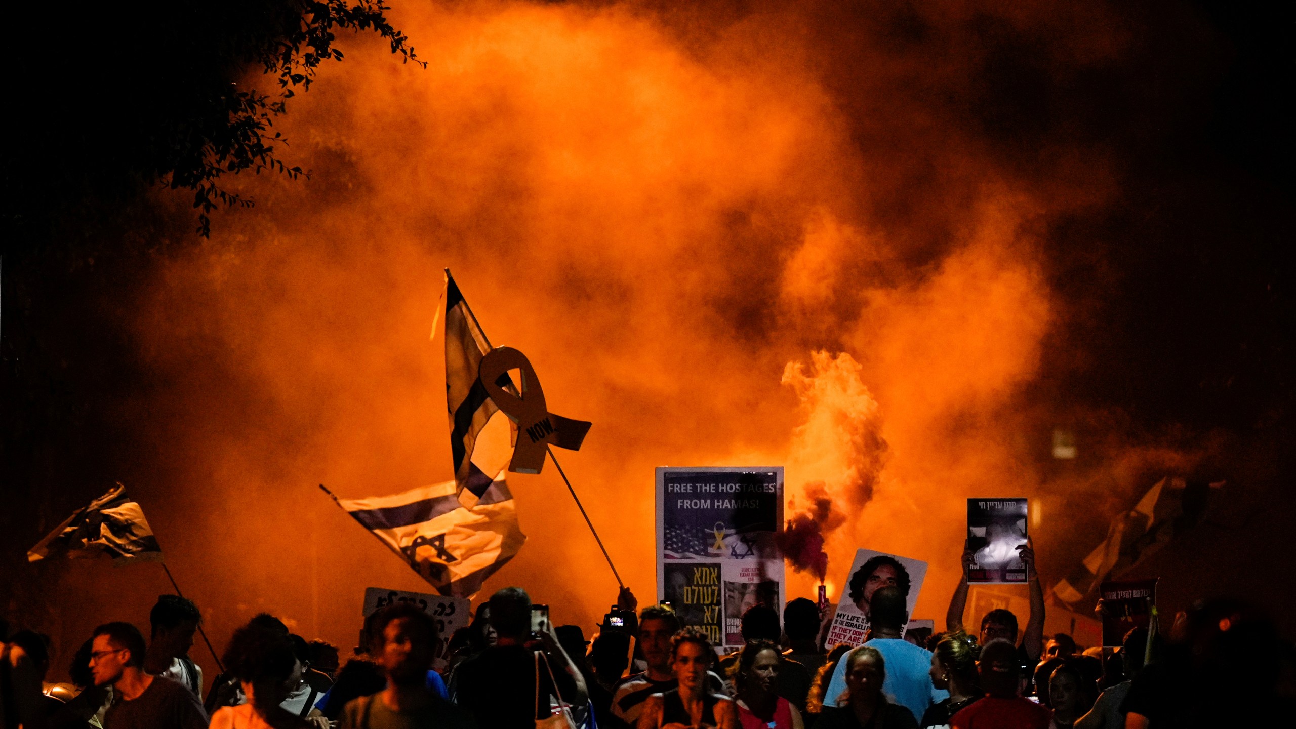 People attend a rally demanding a cease-fire deal and the immediate release of hostages held by Hamas in the Gaza Strip after the deaths of six hostages in the Palestinian territory in Tel Aviv, Israel, on Monday, Sept. 2, 2024. (AP Photo/Ariel Schalit)