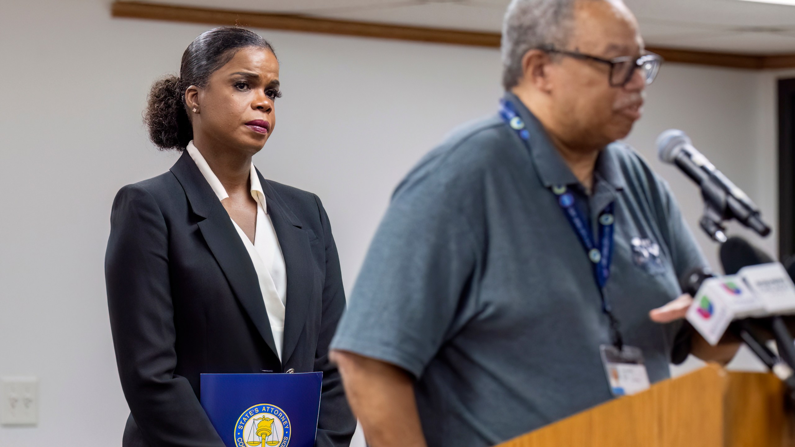 Cook County State's Attorney Kim Foxx, left, listens as Dorval Carter Jr. President of the Chicago Transit Authority speaks to reporters at the Forest Park Village Hall over the shooting death of four people on a Chicago-area transit Blue Line train yesterday morning, Tuesday, Sept. 3, 2024, in Forest Park, Ill. (Tyler Pasciak LaRiviere/Chicago Sun-Times via AP)