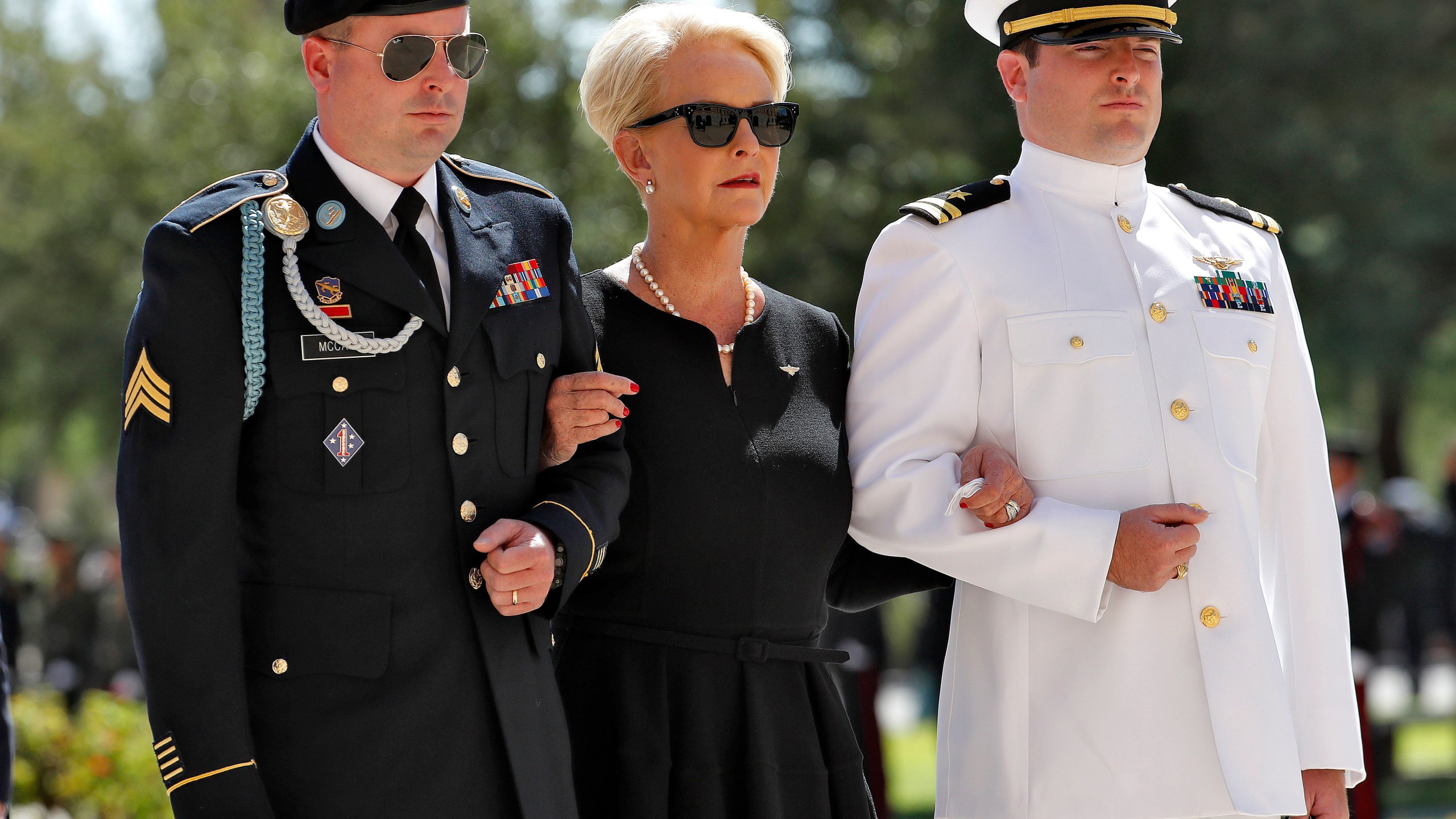 FILE - Cindy McCain, escorted by sons, Jack McCain, right, and Jimmy McCain, follow behind military personal carrying the casket of Sen. John McCain, R-Ariz., into the Capitol rotunda for a memorial service, Aug. 29, 2018, at the Capitol in Phoenix. Jimmy McCain has registered as a Democrat and will vote for Kamala Harris for President in 2024. (AP Photo/Matt York, File)