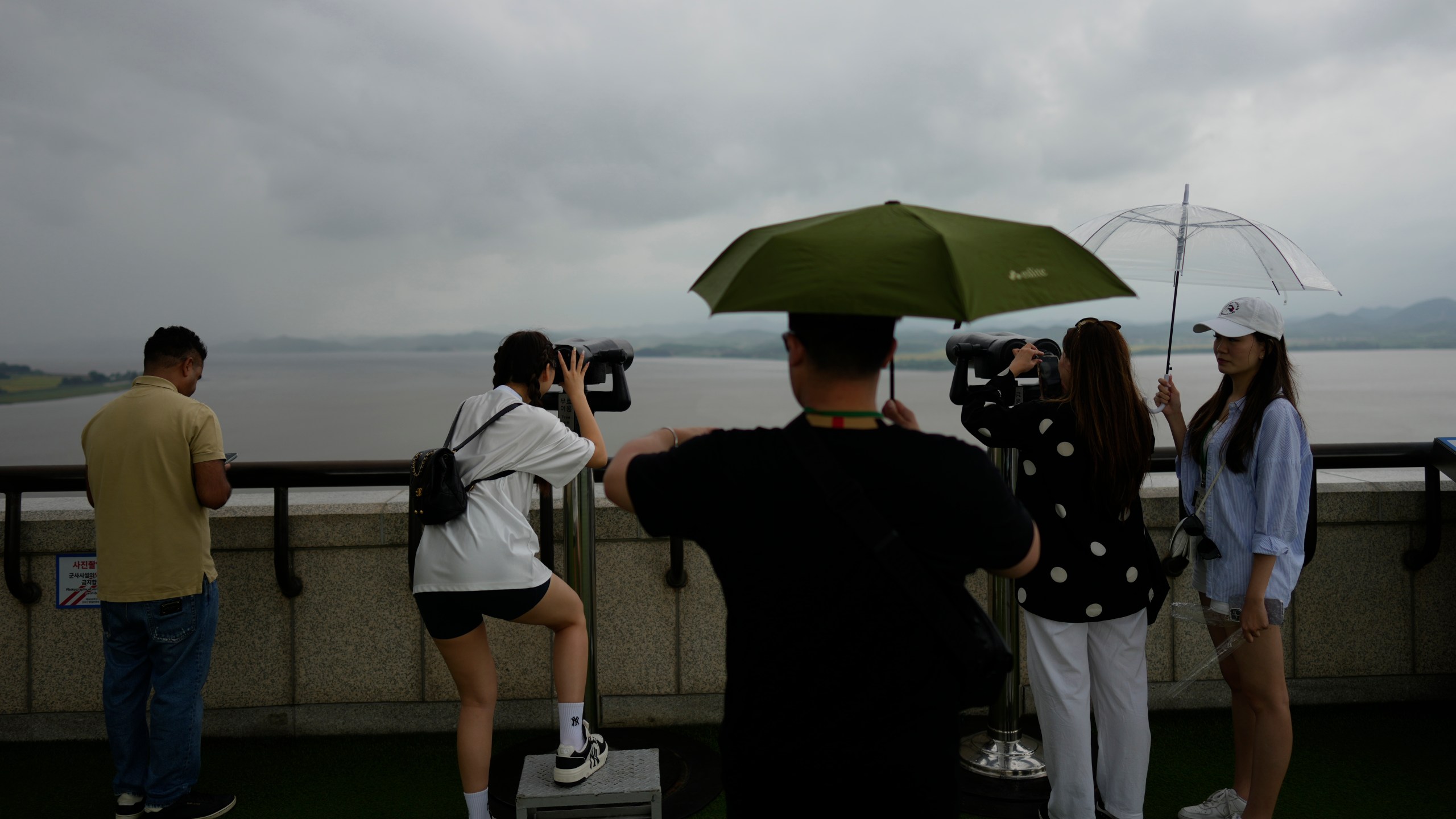 Visitors use binoculars to see the North Korean side from the unification observatory in Paju, South Korea, Thursday, Sept. 5, 2024. (AP Photo/Lee Jin-man)