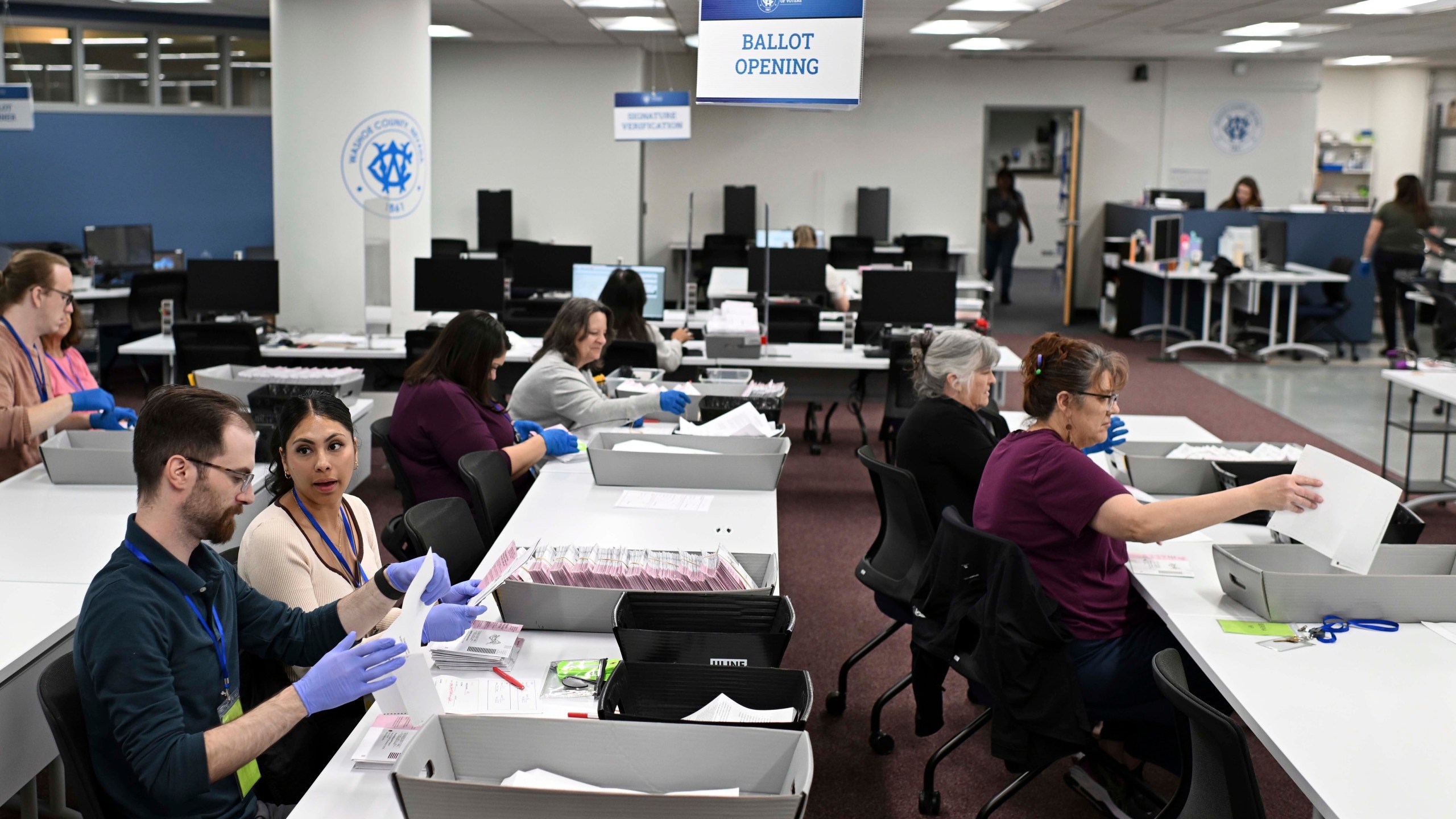 FILE - County employees open ballots in the mail ballot processing room at the Washoe County Registrar of Voters office in Reno, Nev., June 3, 2024. (AP Photo/Andy Barron, File)