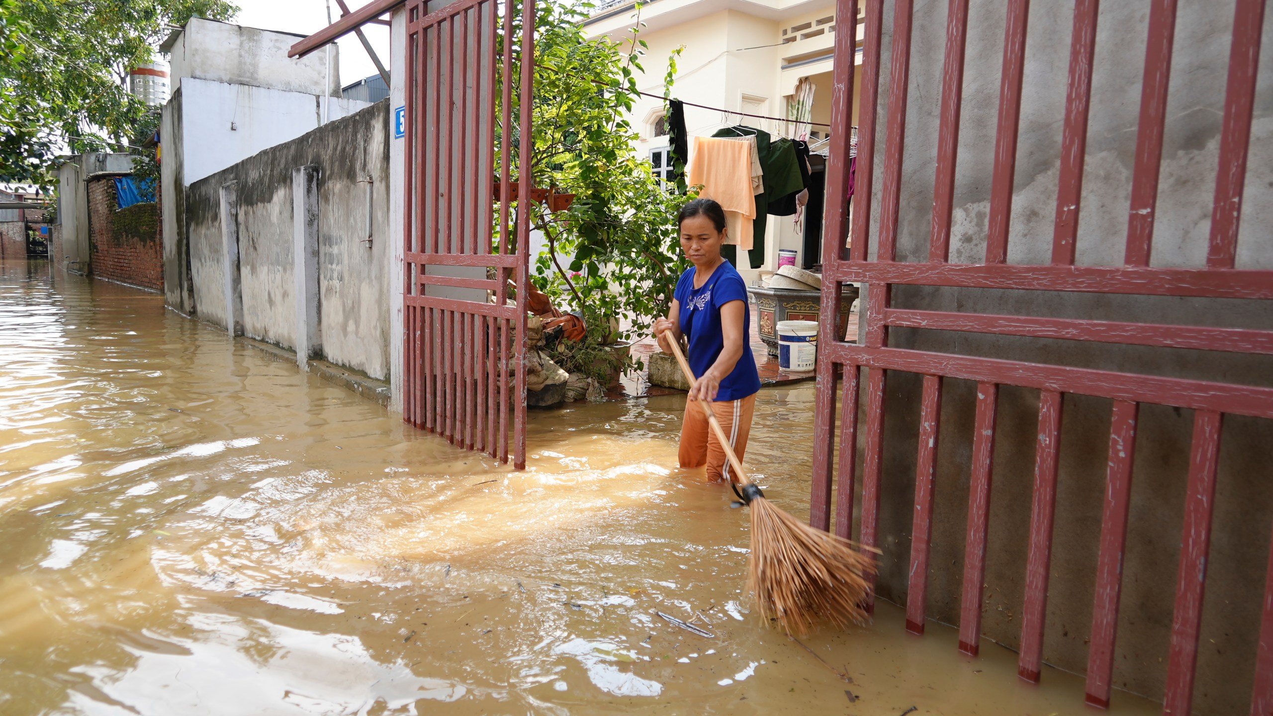 A woman cleans her house as flood recedes in the aftermath of Typhoon Yagi in An Lac village, Hanoi, Vietnam Friday, Sept. 13, 2024. (AP Photo/Hau Dinh)