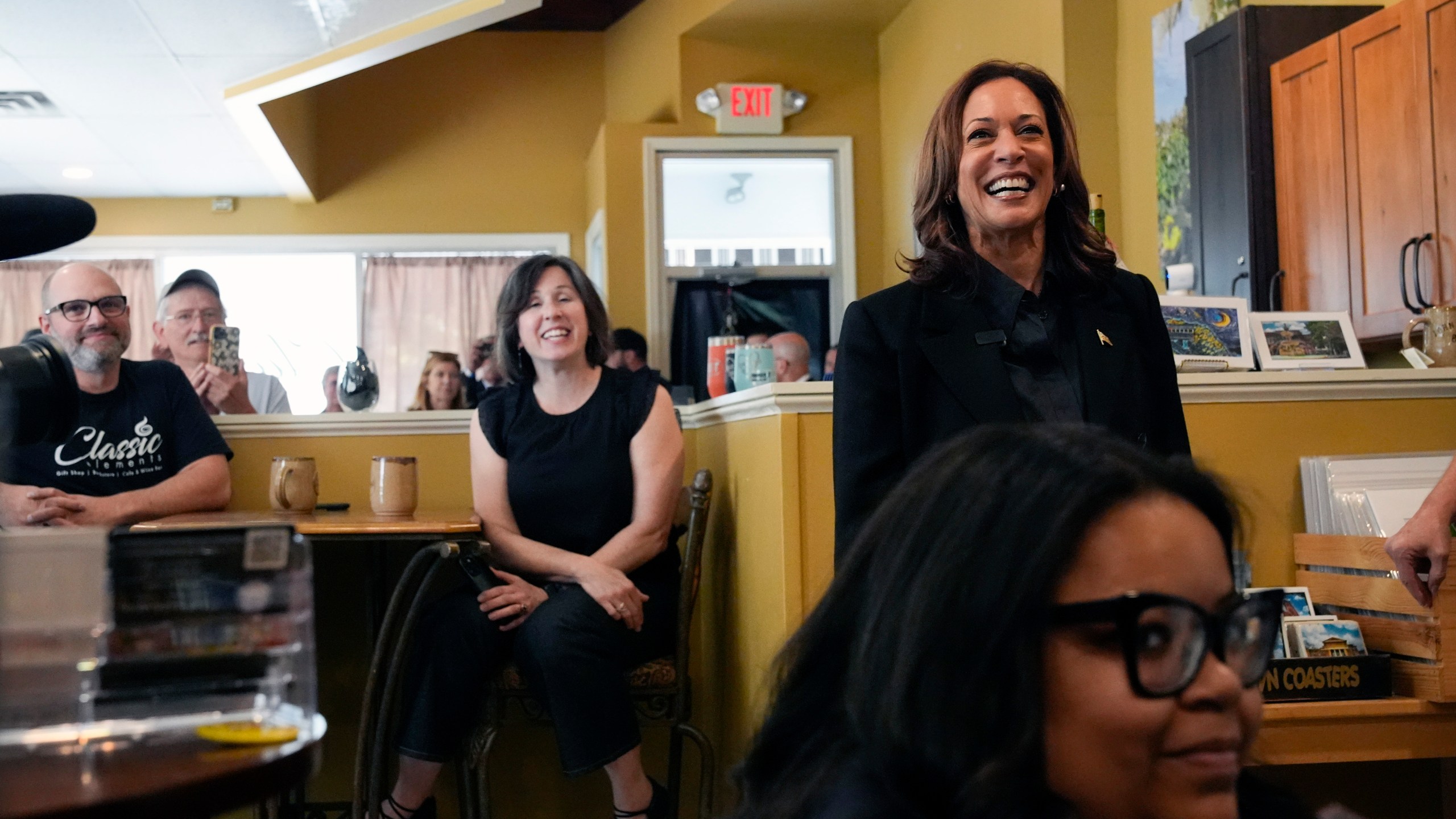 Democratic presidential nominee Vice President Kamala Harris, right, is greeted at Classic Elements, a cafe and bookstore, Friday, Sept. 13, 2024. in Johnstown, Pa. (AP Photo/Jacquelyn Martin)