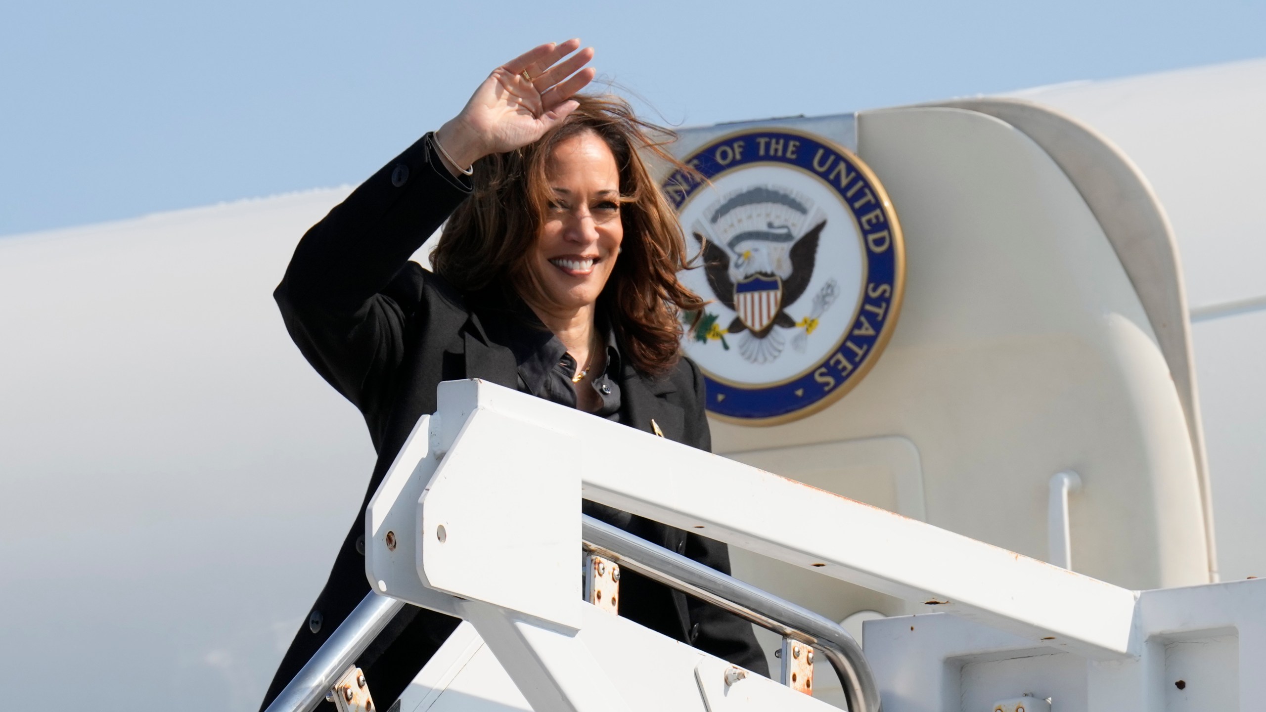 Democratic presidential nominee Vice President Kamala Harris waves to the media as she boards Air Force Two at John Murtha Johnstown-Cambria Airport, in Johnstown, Pa. Friday, Sept. 13, 2024. (AP Photo/Jacquelyn Martin)