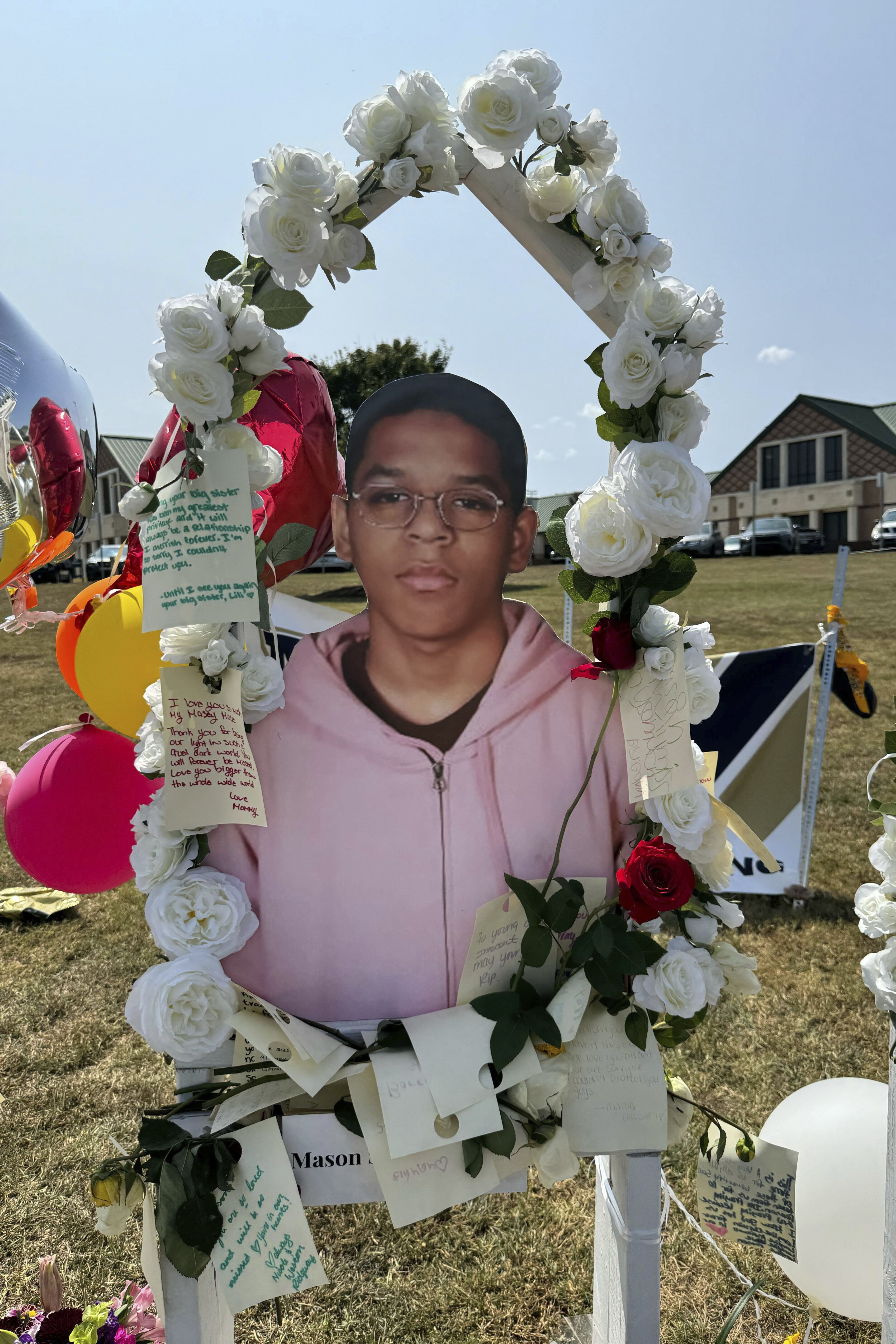 A poster with an image of shooting victim Mason Schermerhorn is displayed at a memorial outside Apalachee High School, Tuesday, Sept. 10, 2024, in Winder, Ga. (AP Photo/Charlotte Kramon)