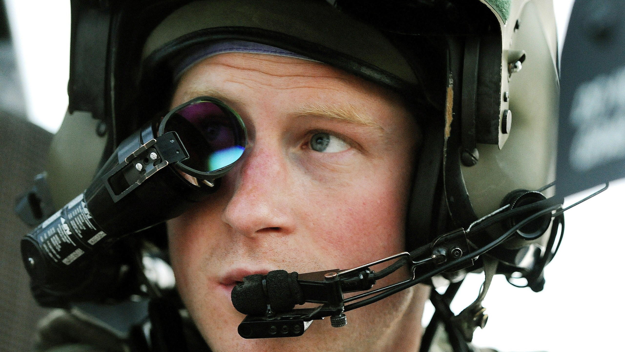 FILE - Britain's Prince Harry or just plain Captain Wales as he is known in the British Army, wears his monocle gun sight as he sits in the front seat of his cockpit at the British controlled flight-line in Camp Bastion southern Afghanistan, Dec. 12, 2012. (AP Photo/ John Stillwell, File)