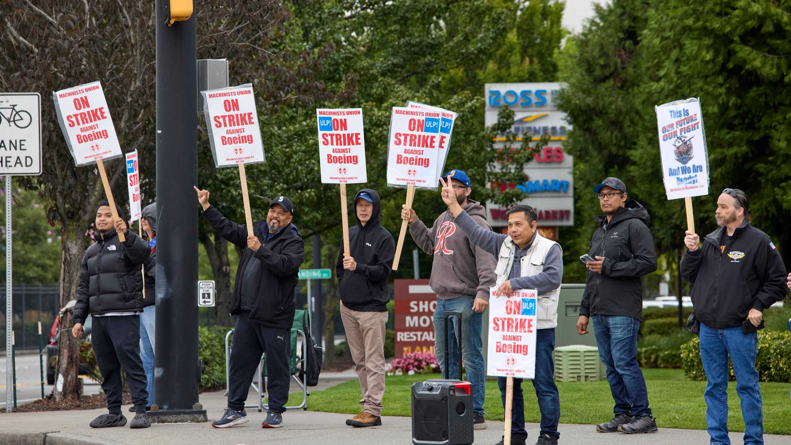 Boeing Machinists Union members react to passing vehicles while on the picket line at the company's factory in Renton, Wash., on Saturday, Sept. 14, 2024. (AP Photo/John Froschauer)