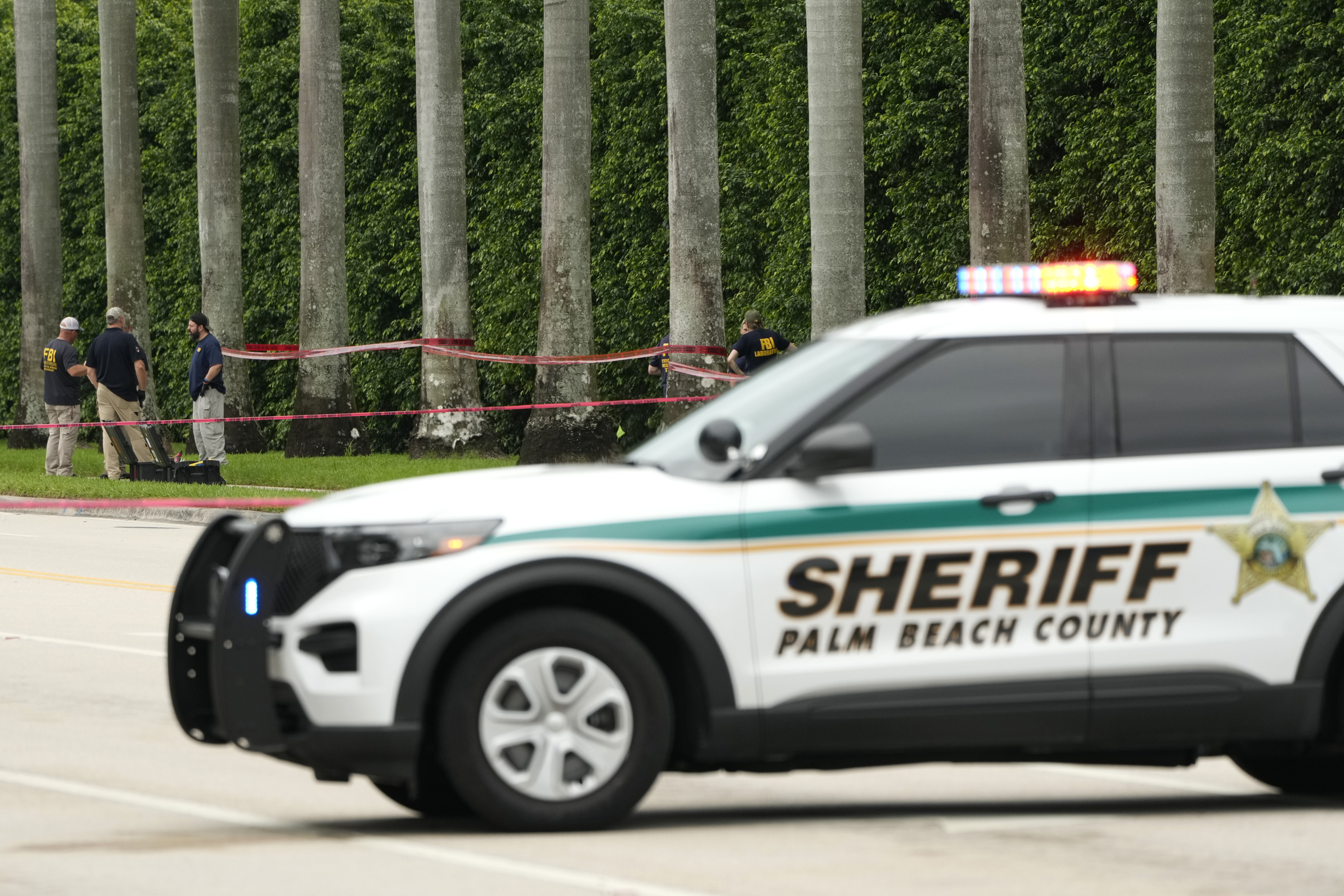 Law enforcement officials work at the scene at the Trump International Golf Club in the aftermath of the apparent assassination attempt of Republican presidential nominee and former President Donald Trump Tuesday, Sept. 17, 2024, in West Palm Beach, Fla. (AP Photo/Lynne Sladky)