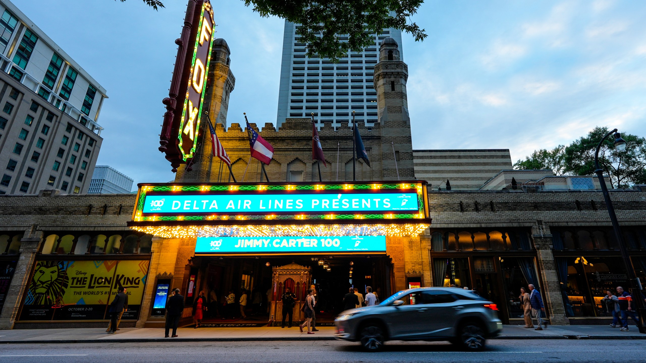 People wait in line ahead of a "Jimmy Carter 100: A Celebration in Song," concert at the Fox Theatre, Tuesday, Sept. 17, 2024, in Atlanta. Former President Carter turns 100-years old on Oct. 1. (AP Photo/Mike Stewart)