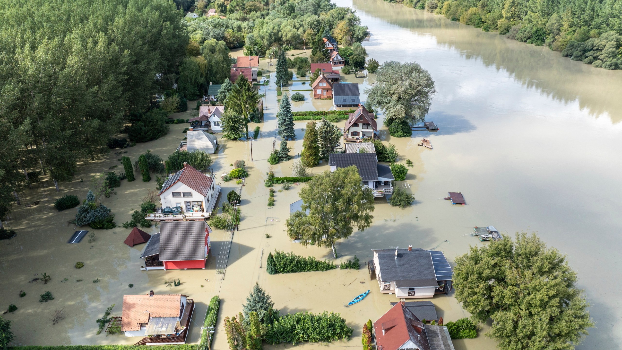 An aerial picture taken with a drone shows the flooded resort village of Venek and the swollen Danube River near Gyor, Hungary, Tuesday, September 17, 2024. (Gergely Janossy/MTI via AP)