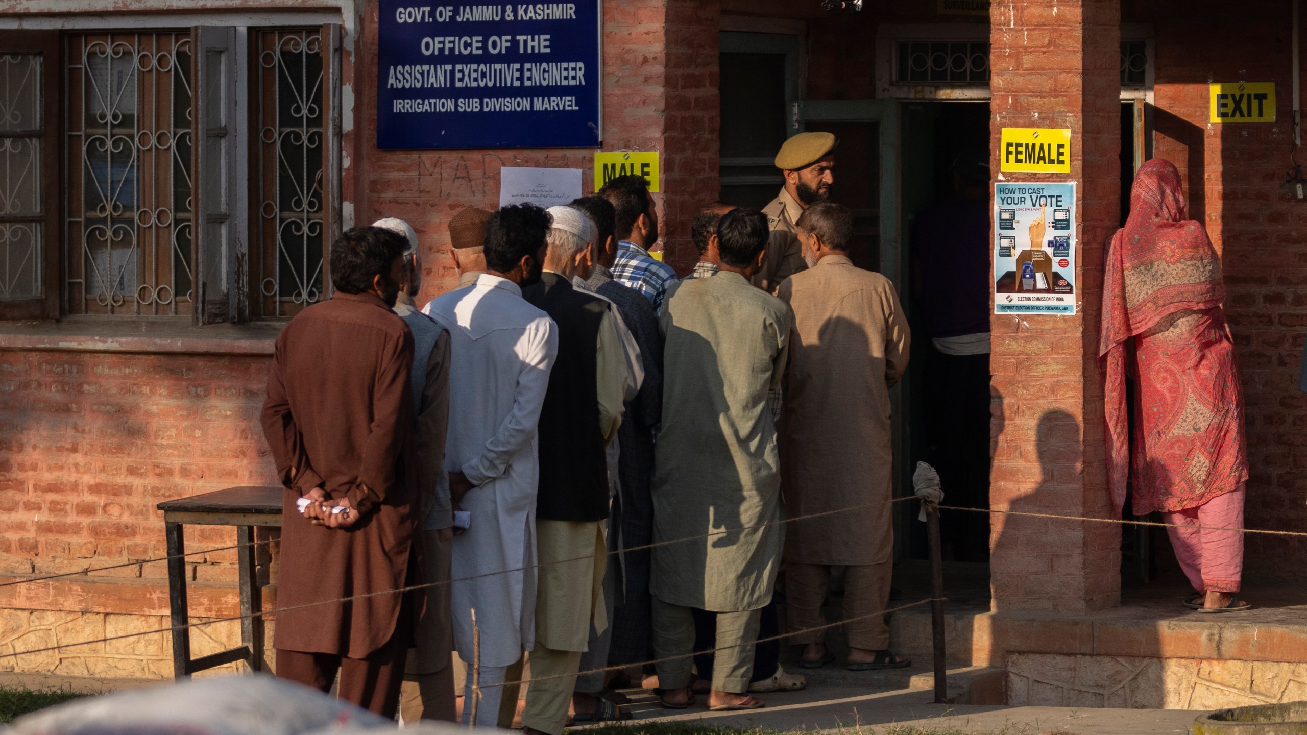 Kashmiri's queue up at a polling booth to cast their vote in Marval, south of Srinagar, Indian controlled Kashmir, Wednesday, Sept. 18, 2024. (AP Photo/Dar Yasin)