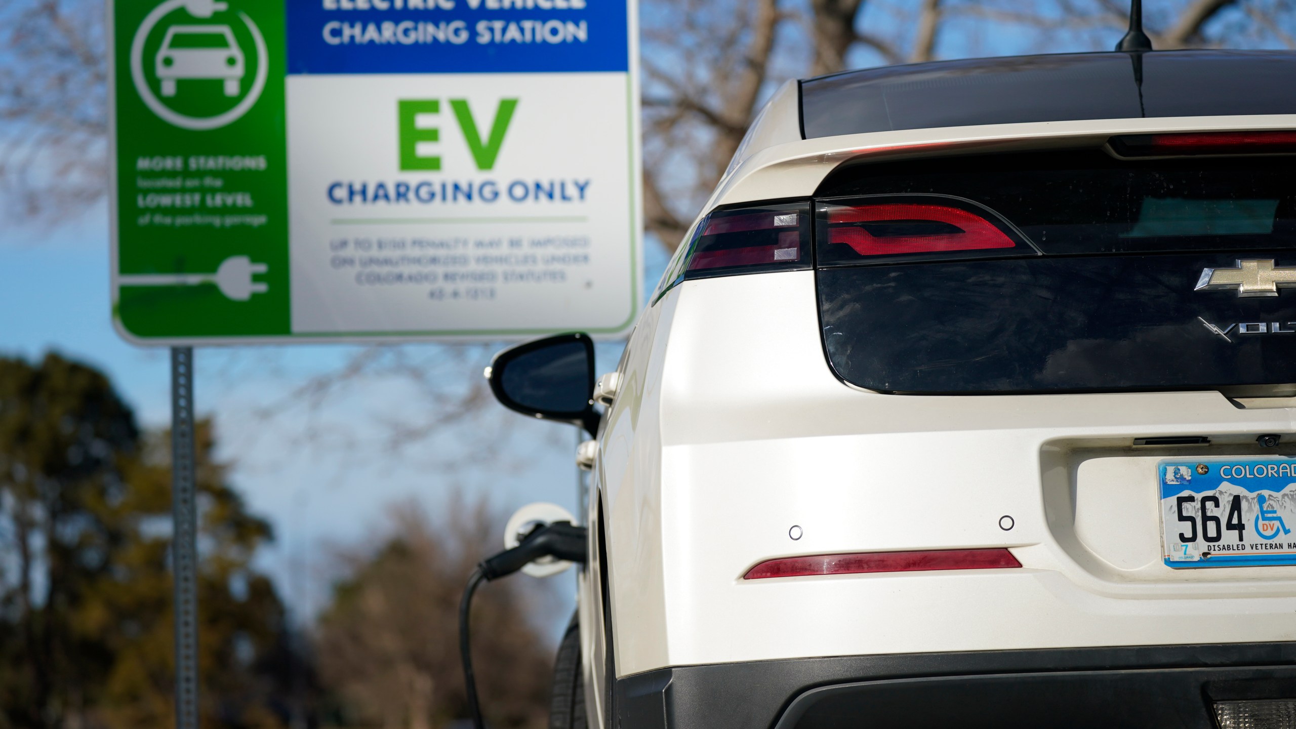 FILE - A Chevrolet Volt charges at at a station outside the Denver Museum of Nature and Science Tuesday, Jan. 5, 2020, in east Denver. (AP Photo/David Zalubowski, File)