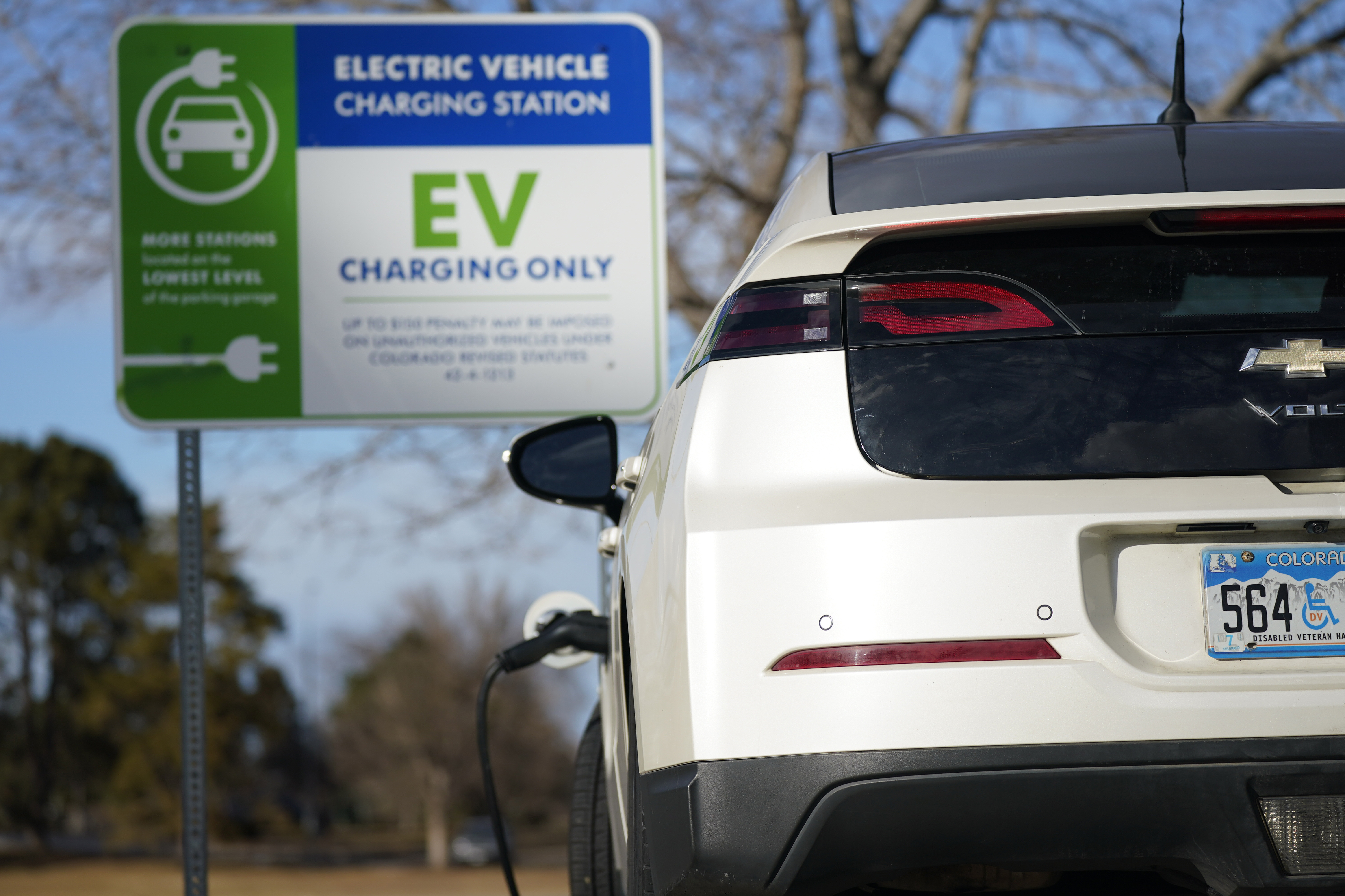 FILE - A Chevrolet Volt charges at at a station outside the Denver Museum of Nature and Science Tuesday, Jan. 5, 2020, in east Denver. (AP Photo/David Zalubowski, File)