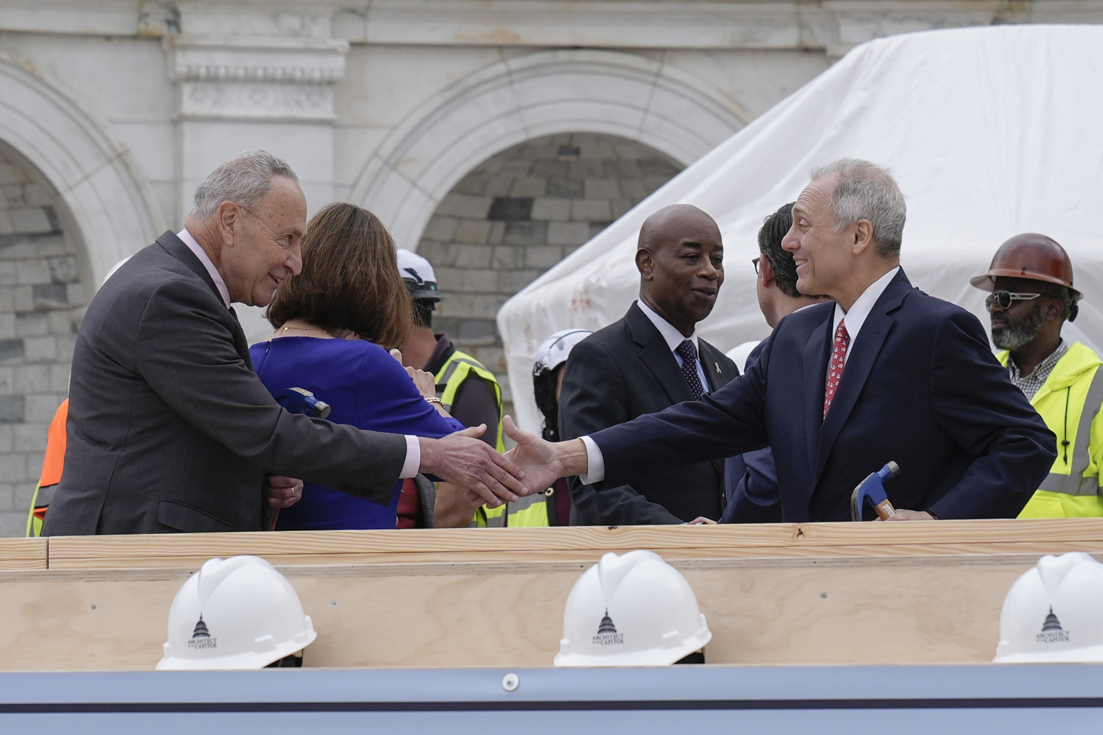 House Majority Leader Steve Scalise, R-La., right and Senate Majority Leader Chuck Schumer, D-N.Y., are seen after the First Nail Ceremony marking the beginning of construction of the 2025 Presidential Inauguration platform, on the steps of the Capitol, Wednesday, Sept. 18, 2024, in Washington. (AP Photo/Mariam Zuhaib)