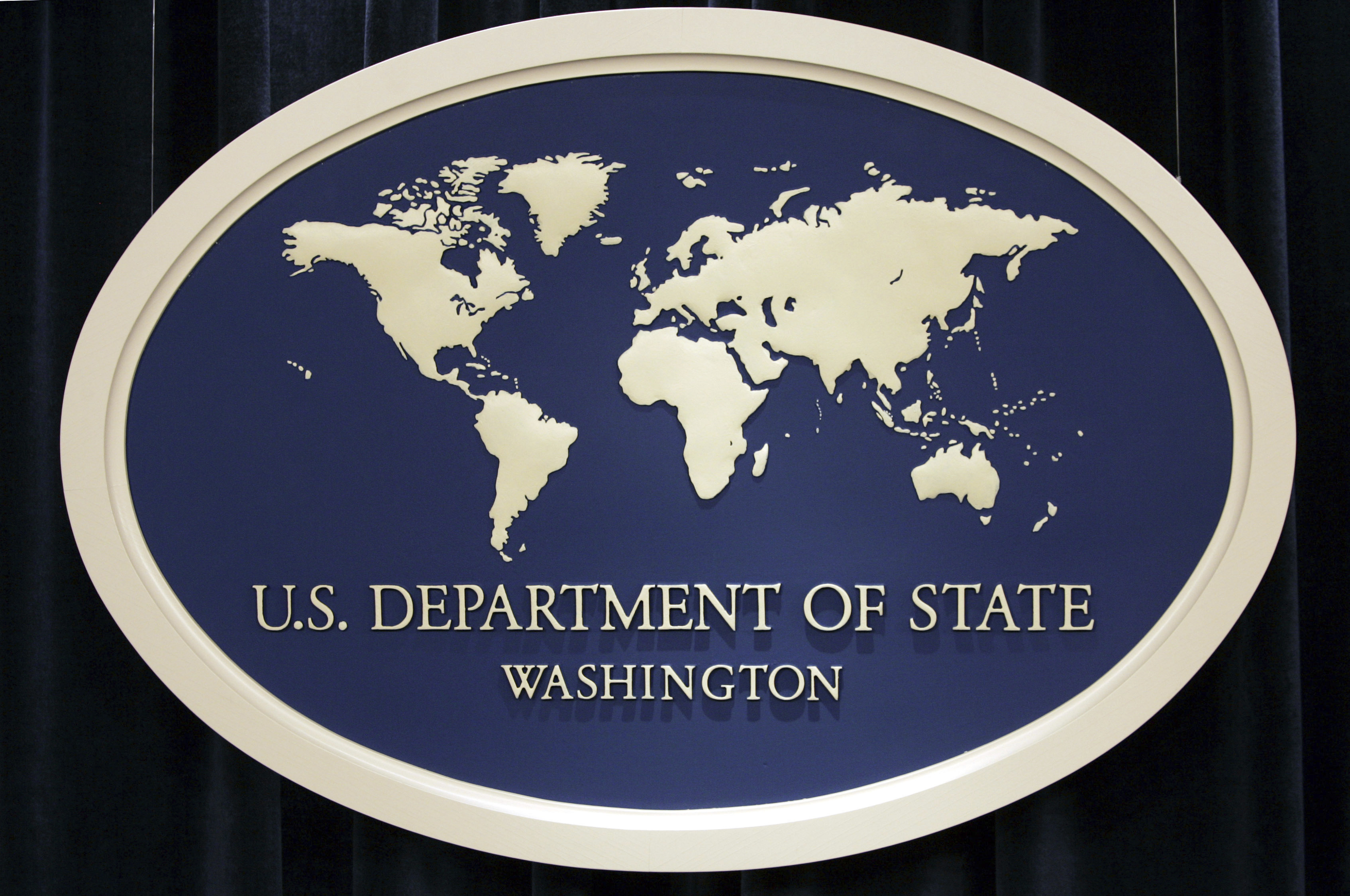 FILE - U.S. Department of State sign is seen at the State Department in Washington, Aug. 10, 2006. The State Department’s internal watchdog says that officials did not follow proper protocol when handling the security clearance suspension of the U.S. special envoy for Iran following allegations last year that he may have mishandled classified information. (AP Photo/Charles Dharapak, File)