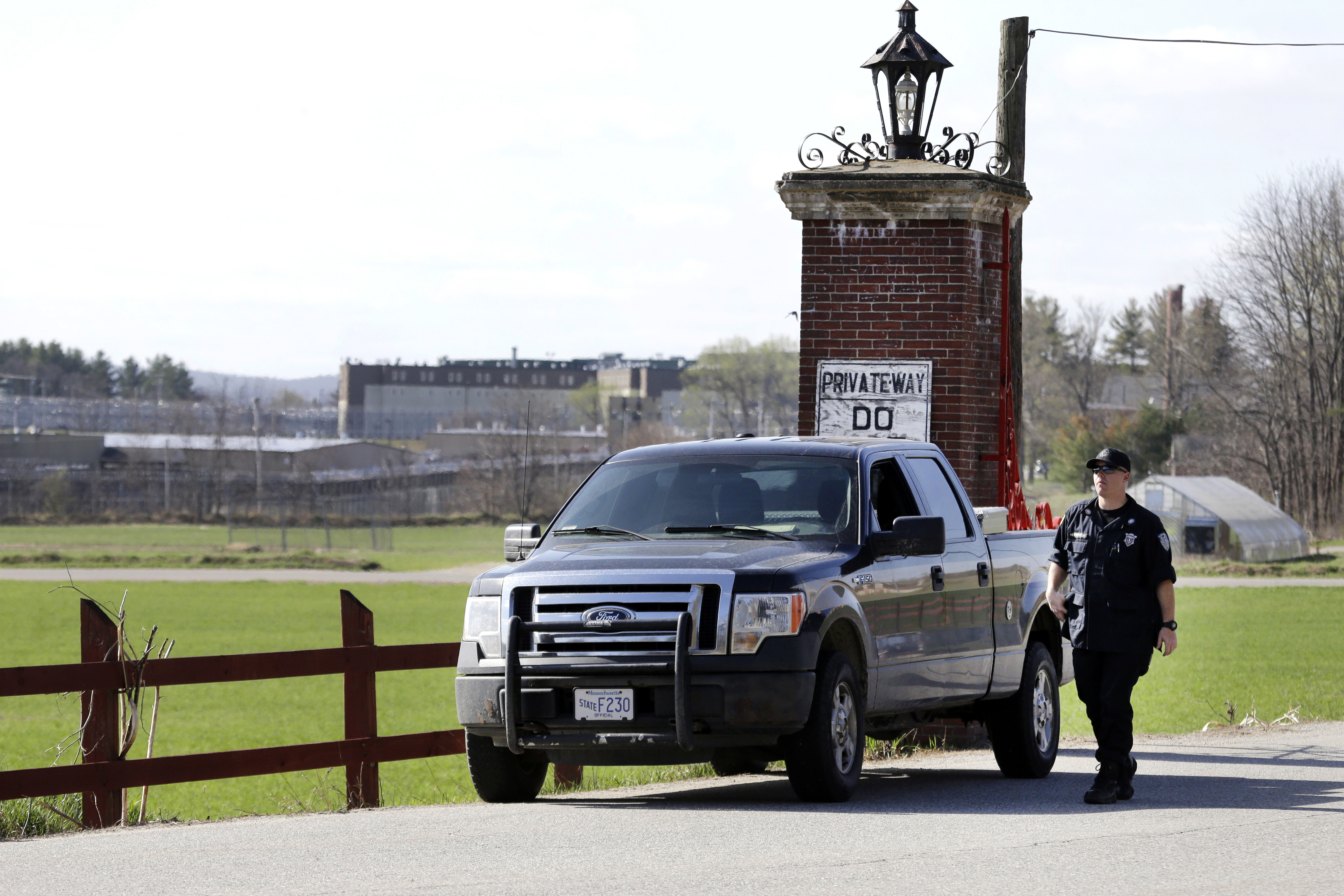 FILE - A police officer guards an entrance to the Souza-Baranowski Correctional Center, Wednesday, April 19, 2017, in Shirley, Mass. (AP Photo/Elise Amendola, File)