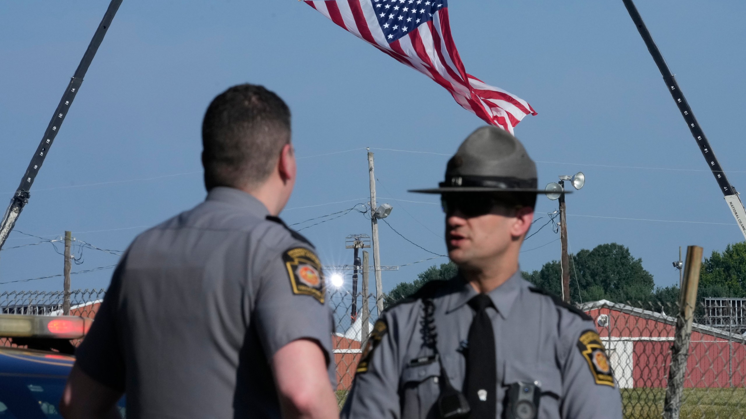 FILE - Police officers stand at a road leading to the site of the Trump rally, where access is closed, as investigations into the assassination attempt on former President Donald Trump continue, in Butler, Pa., July 14, 2024. (AP Photo/Sue Ogrocki, File)