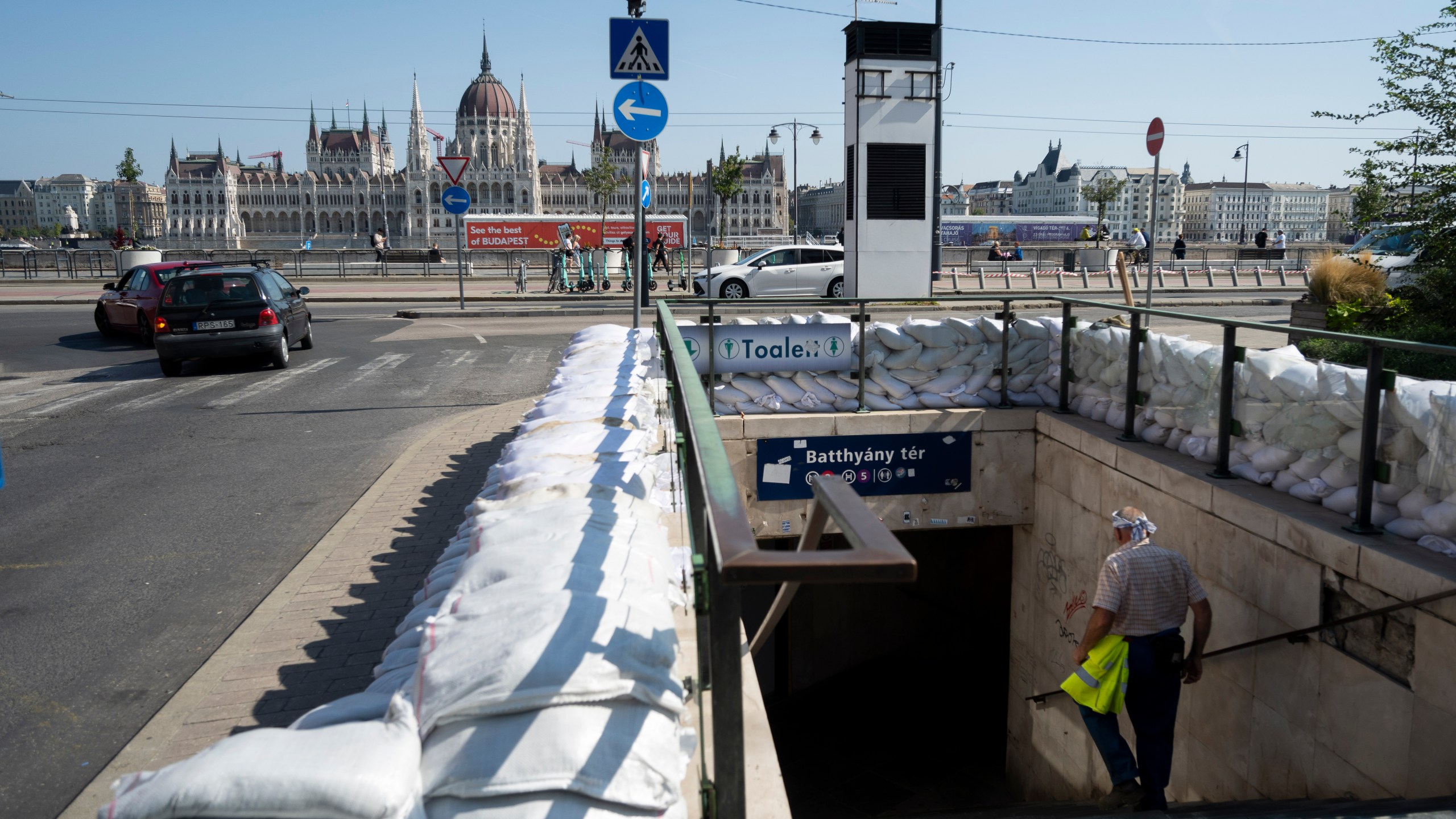 A workers walks down to a metro station protected by sandbags as the Danube river floods it's banks, central Budapest, Hungary, Thursday, Sept. 19, 2024. (AP Photo/Denes Erdos)