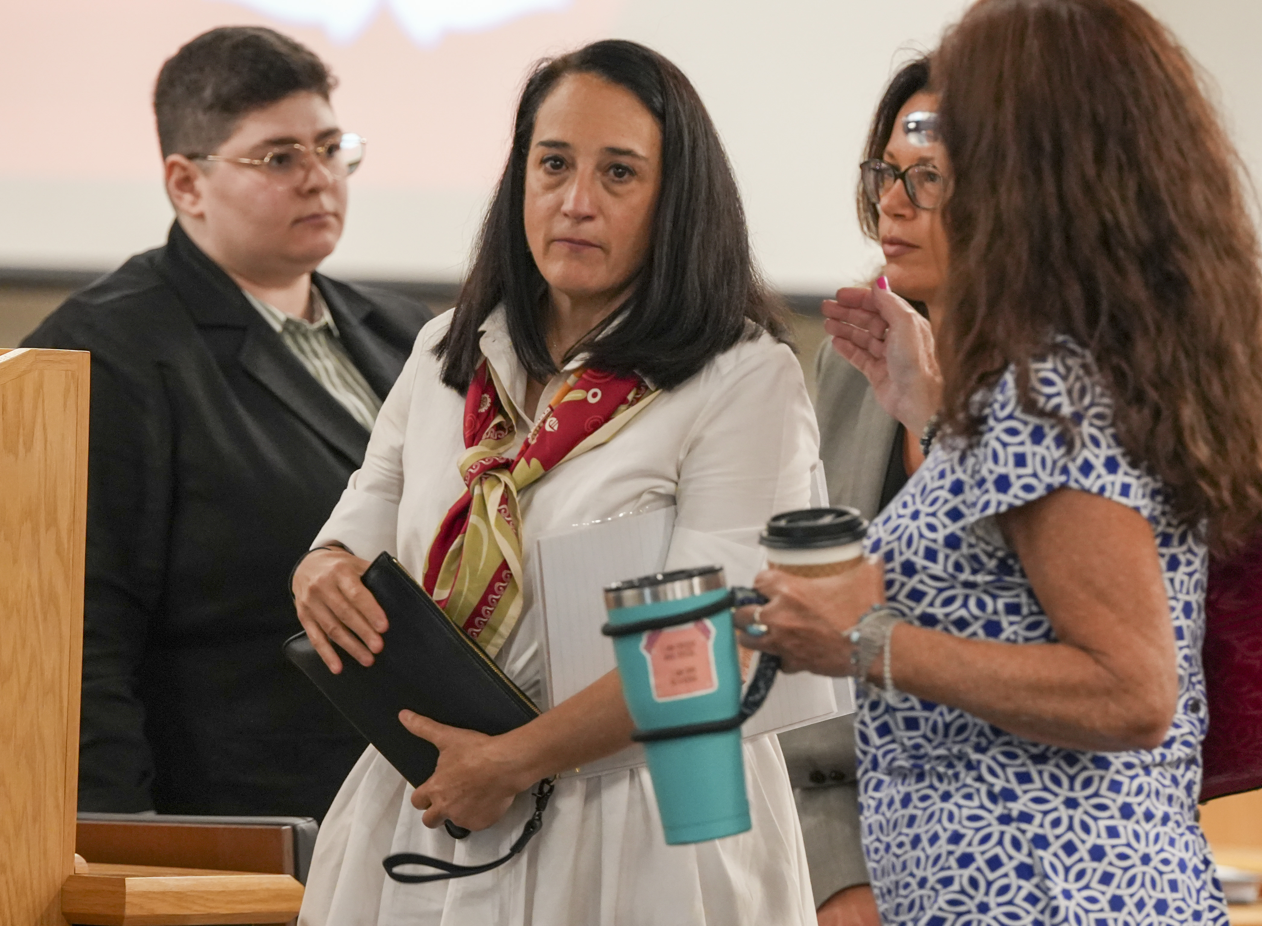 Renata Rojas, OceanGate mission specialist, center, pauses during at the Titan marine board formal hearing inside the Charleston County Council Chambers, Thursday, Sept. 19, 2024, in North Charleston, S.C. (Corey Connor via AP, Pool)