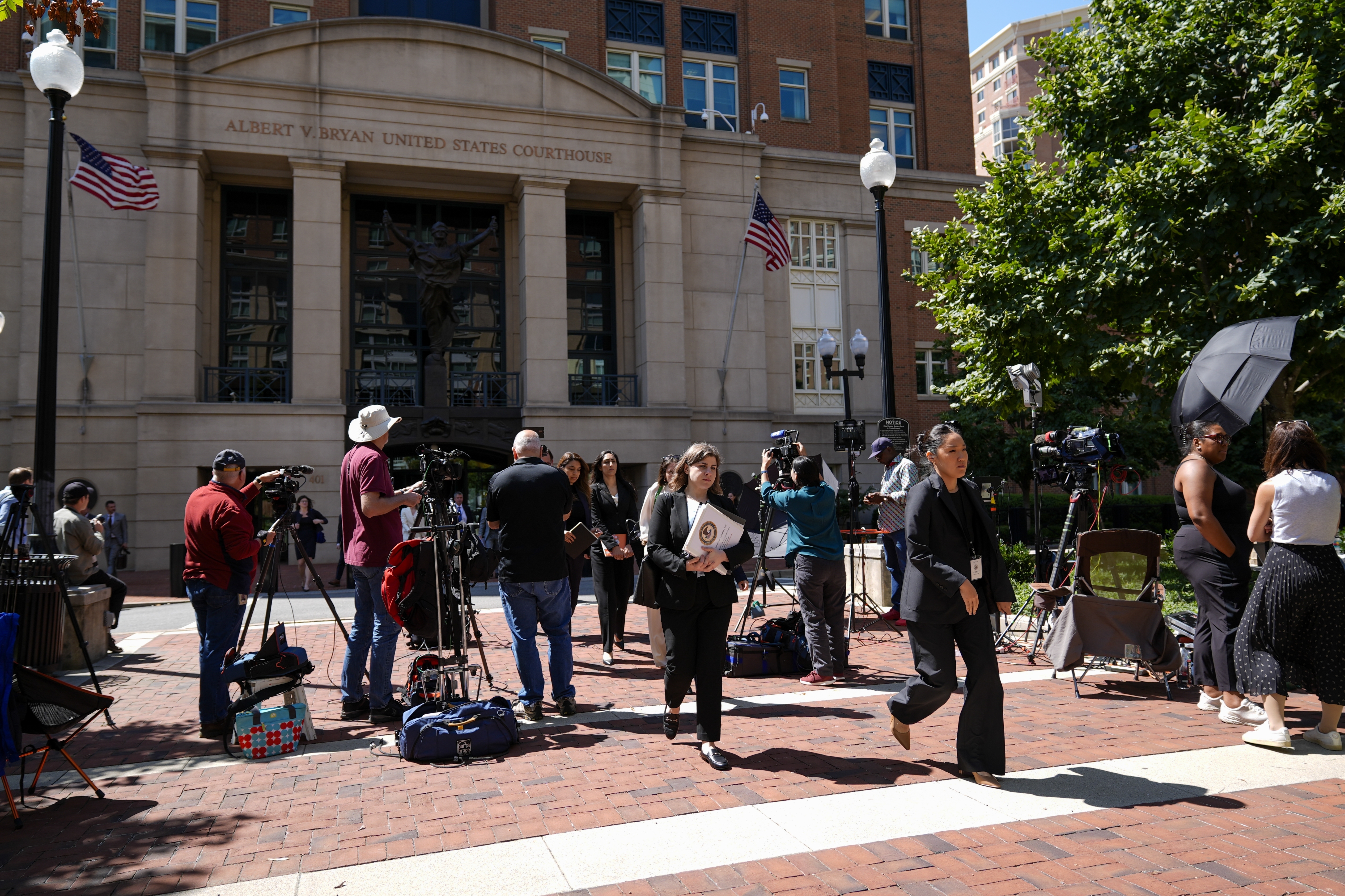 Lawyers and legal assistants leave the U.S. District Court for the Eastern District of Virginia for a lunch break in the Department of Justice's antitrust trial against tech giant Google, Monday, Sept. 9, 2024, in Alexandria, Va. (AP Photo/Stephanie Scarbrough)