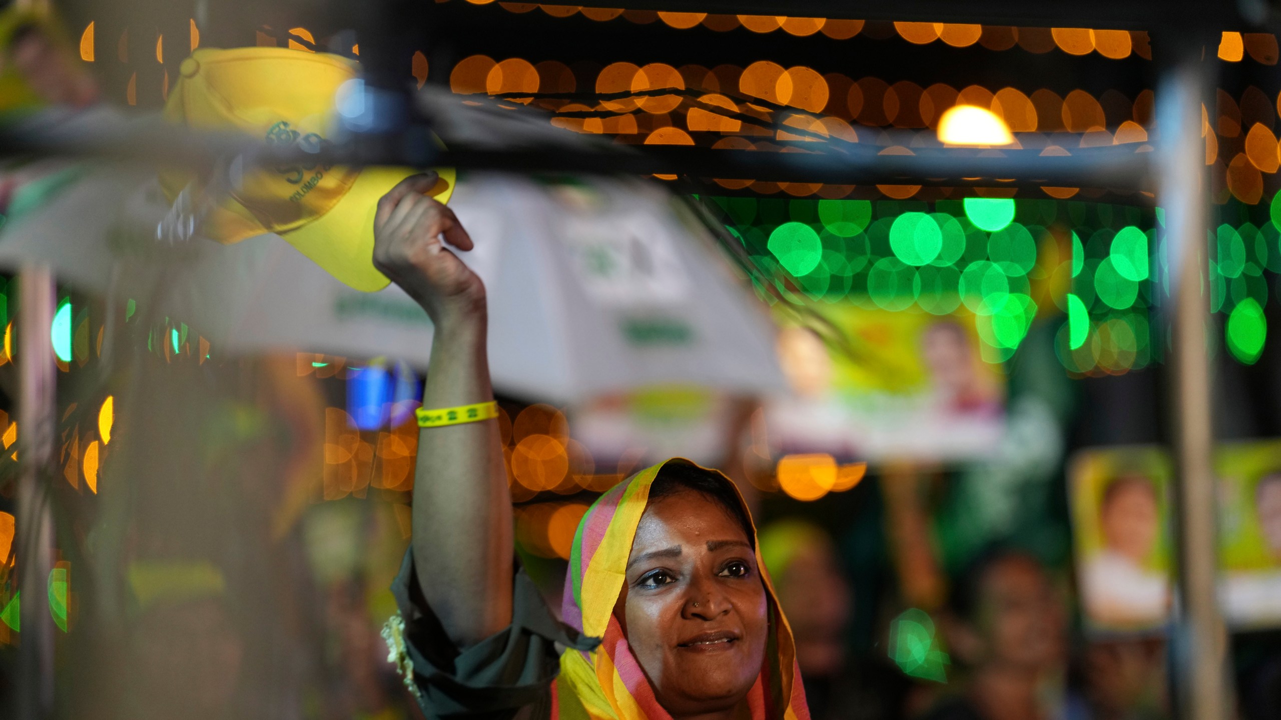 A woman listens to Sajith Premadasa, unseen, the presidential candidate and opposition leader of the Samagi Jana Balawgaya or United People's Power party, at an election rally, in Colombo, Sri Lanka, Wednesday, Sept. 18, 2024. (AP Photo/Rajesh Kumar Singh)