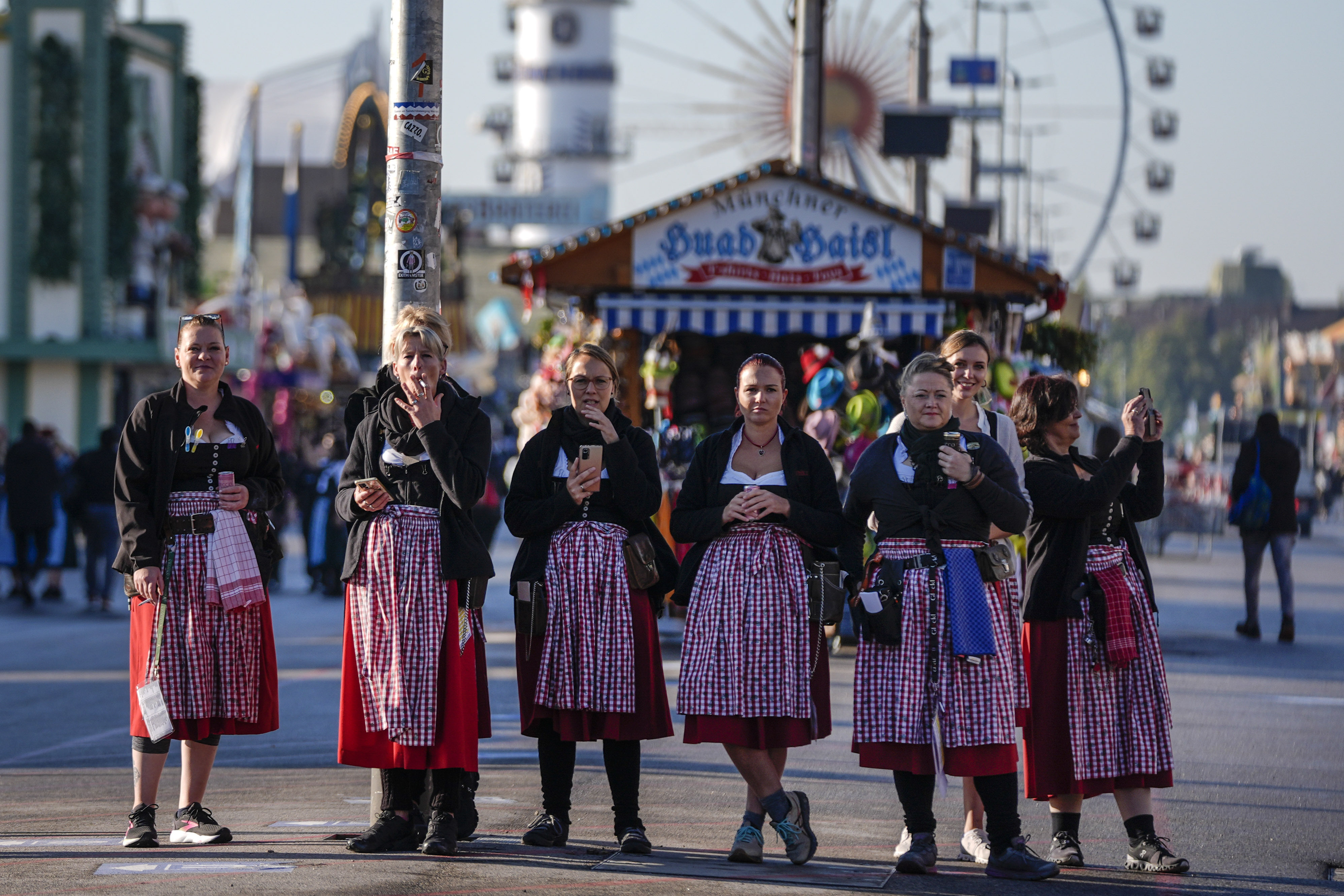 Waitresses wait for the gate opening before the start of the 189th 'Oktoberfest' beer festival in Munich, Germany, Saturday, Sept. 21, 2024. (AP Photo/Matthias Schrader)