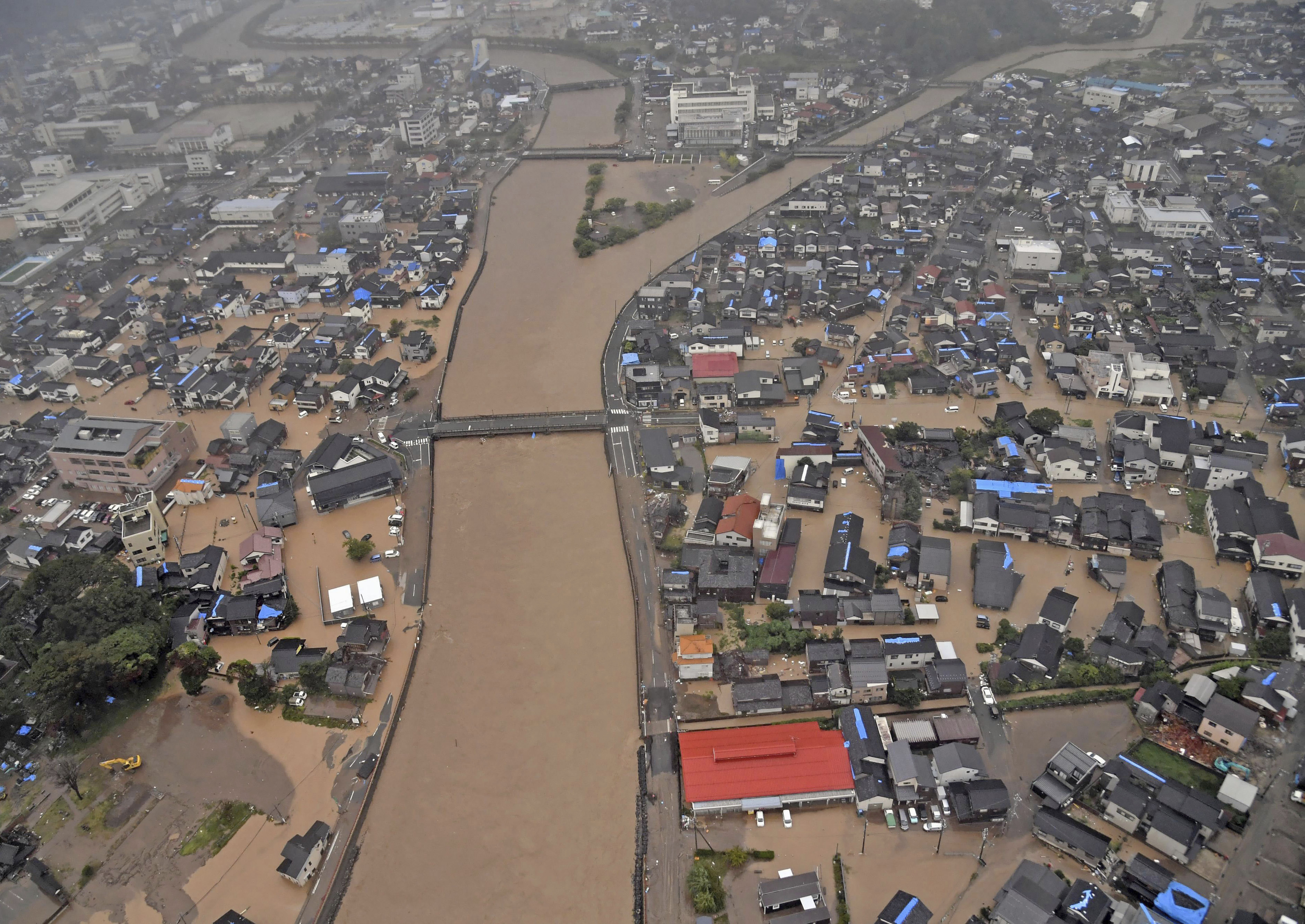 This aerial photo shows the flooded Kawarada river and submerged area after heavy rain in Wajima, Ishikawa prefecture, Saturday, Sept. 21, 2024. (Kyodo News via AP)