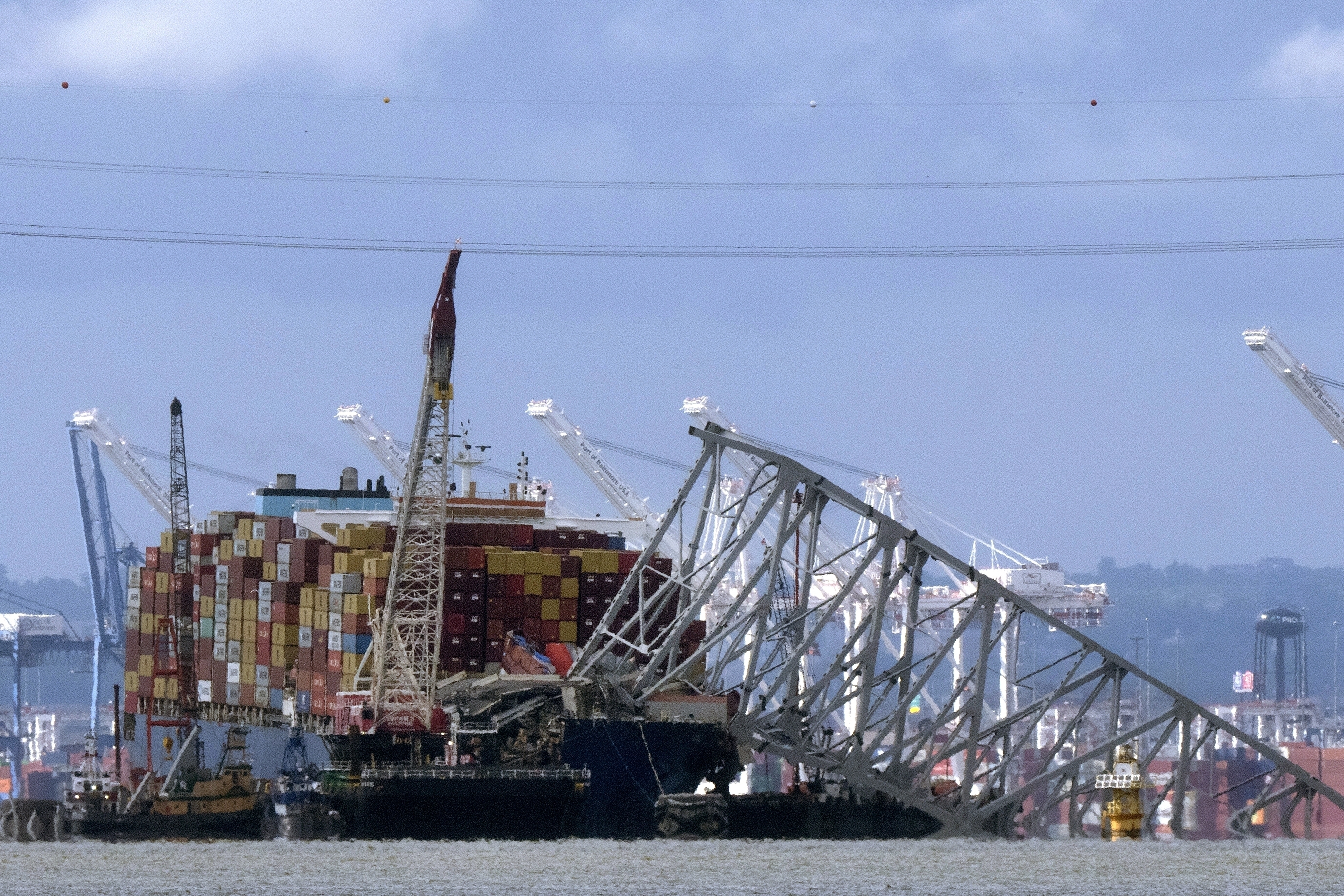 FILE - The collapsed Francis Scott Key Bridge rests on the container ship Dali, May 12, 2024, in Baltimore, as seen from Riviera Beach, Md. (AP Photo/Mark Schiefelbein, File)