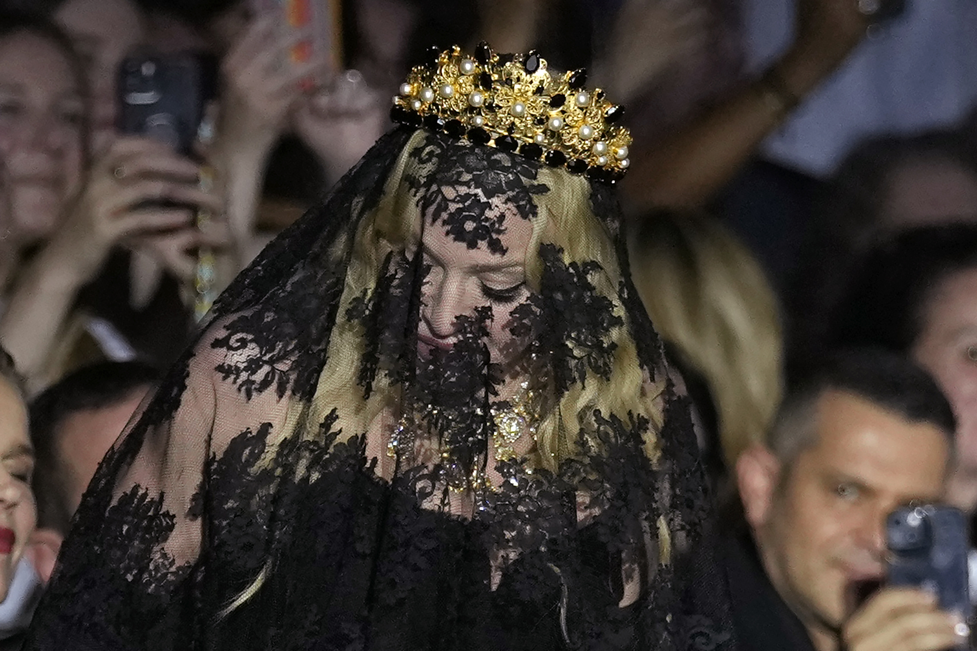 Madonna stands at the end of the Dolce & Gabbana Spring Summer 2025 fashion show, that was presented in Milan, Italy, Saturday, Sept. 21, 2024. (AP Photo/Antonio Calanni)