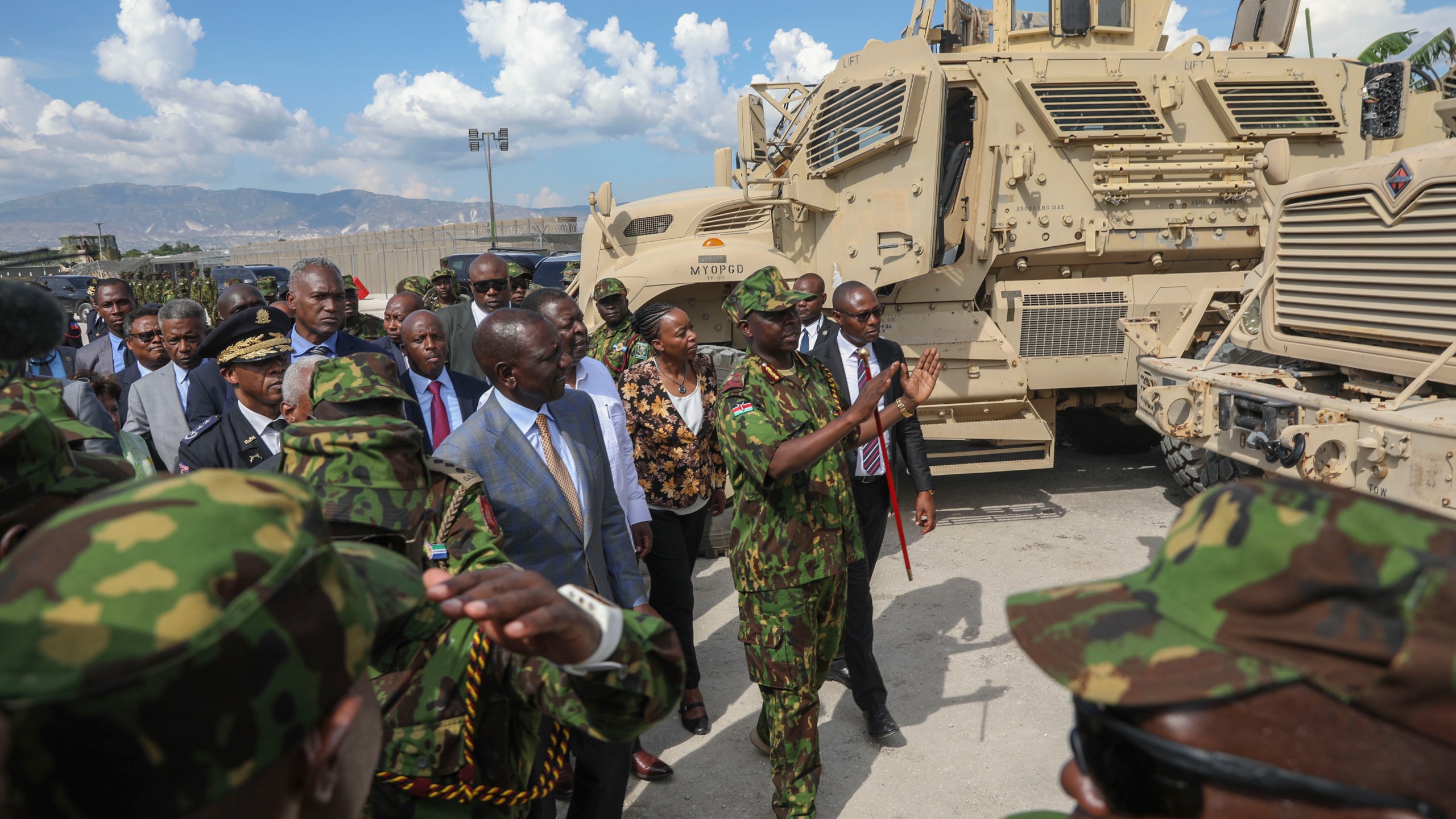 Kenya's President William Ruto, center left, visits Kenyan police, part of a UN-backed multinational force, at their base in Port-au-Prince, Haiti, Saturday, Sept. 21, 2024. (AP Photo/Odelyn Joseph)